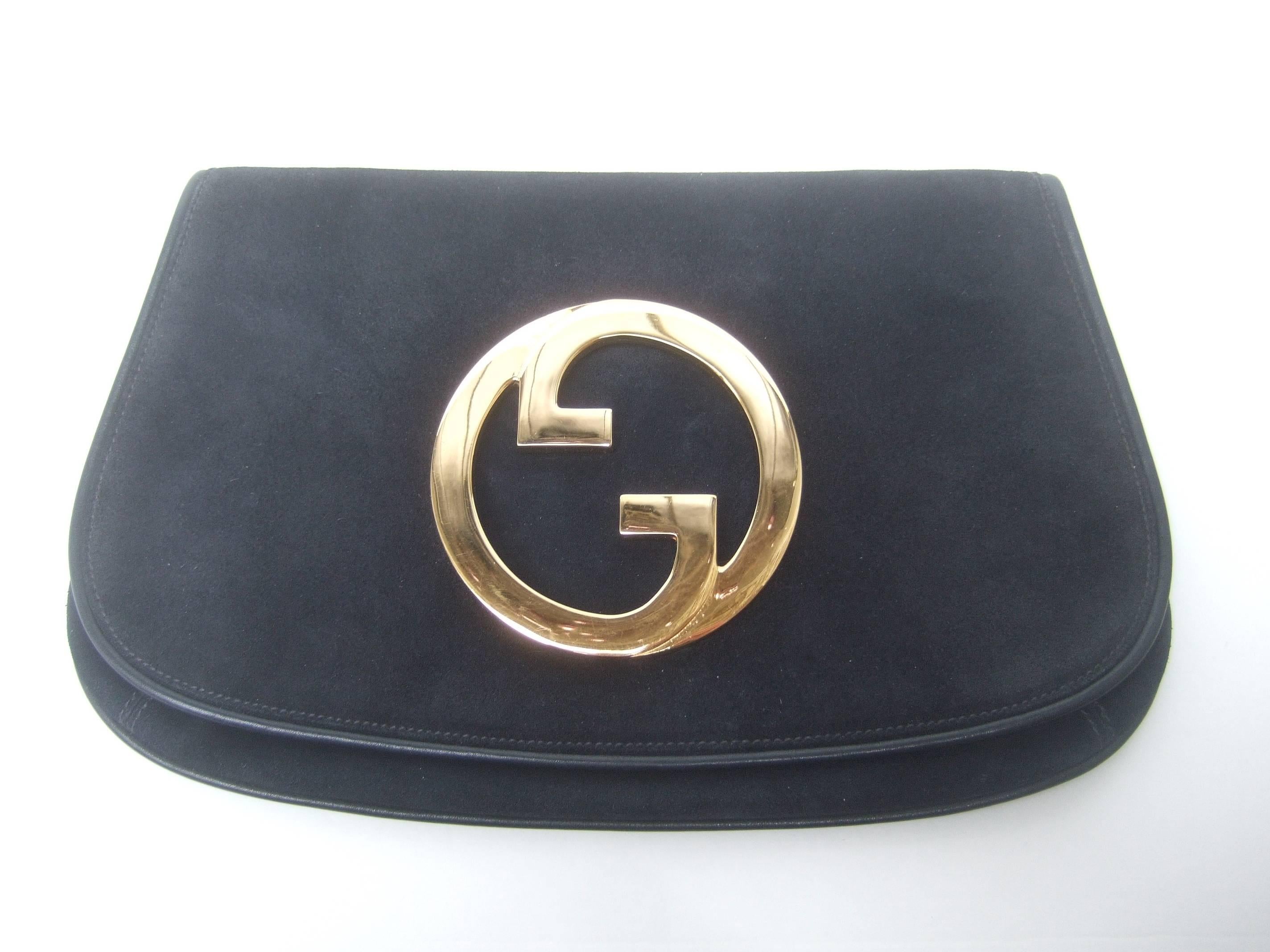 Gucci Italy Black suede blondie clutch bag ca 1970s
The iconic clutch bag is covered with plush
doeskin suede

The Italian clutch is adorned with Gucci's 
massive gilt metal interlocked initials 
Framed with subtle black leather piping

The