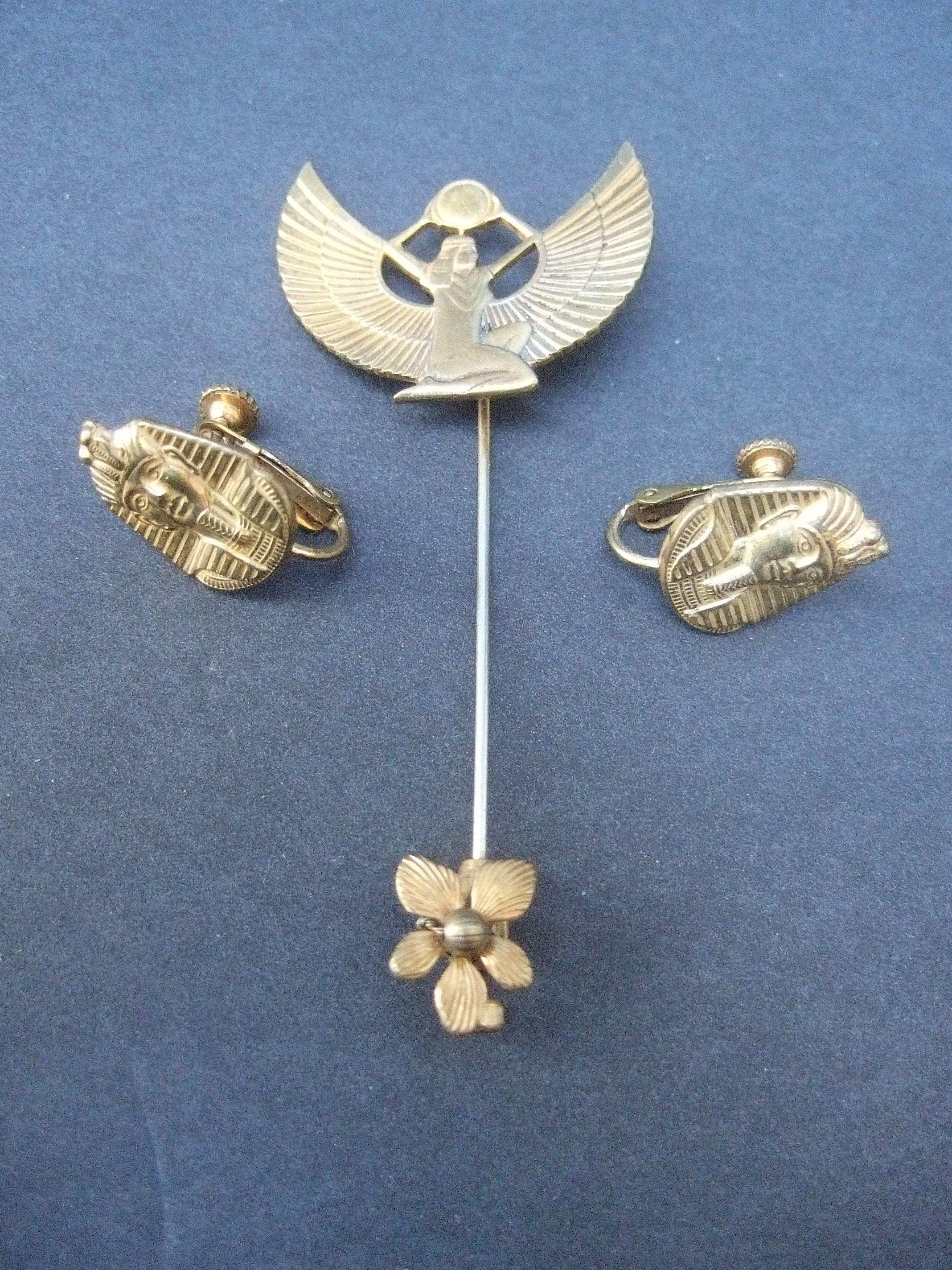 Miriam Haskell Egyptian revival stick pin & earrings ca 1970
The unique stick pin is designed with a stylized Egyptian
winged goddess

The earrings are adorned with Pharaoh mask 
Both the stick pin and earrings are designed 
with Haskell's