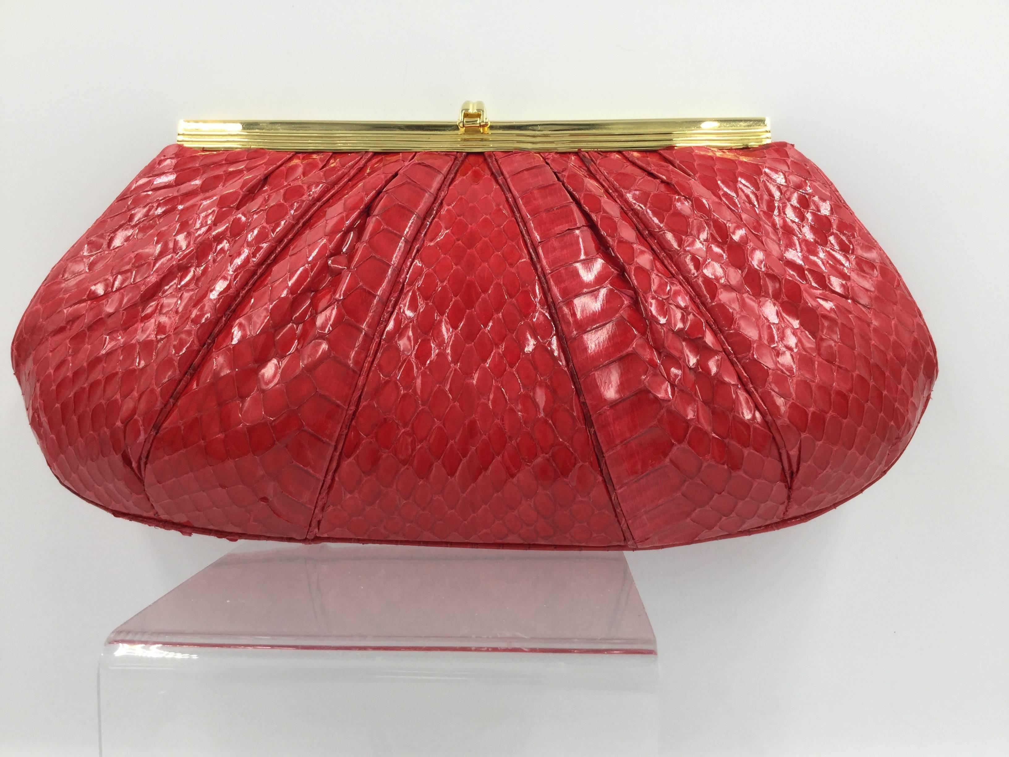 
Gorgeous deep red python handbag by Judith Leiber.

Can be carried as a clutch or as a shoulder bag from it's long 
gilt metal chain that tucks neatly inside when not required.

Sleek and elegant hand-pleated design of glossy, highly glazed,