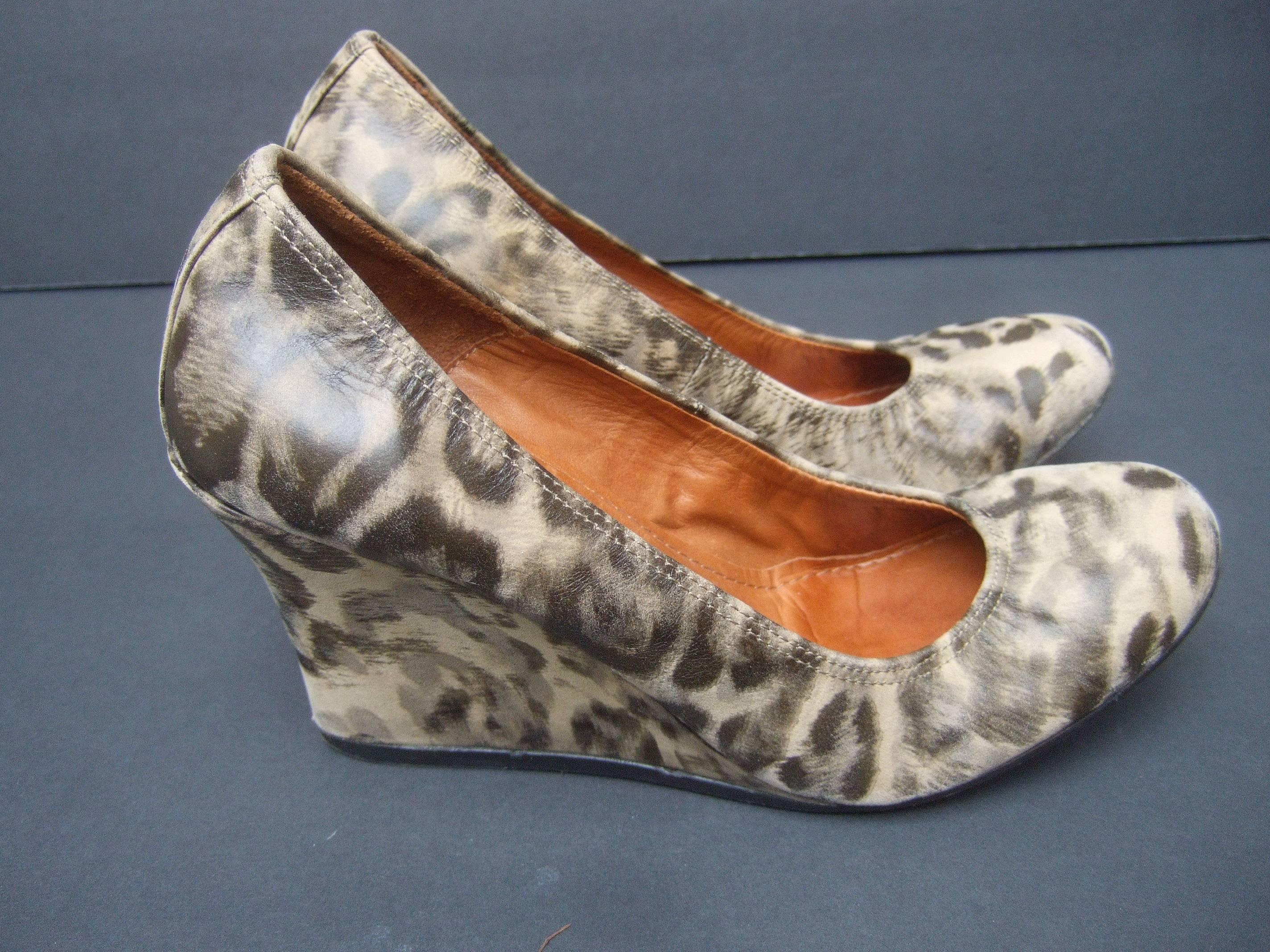 Lanvin Paris Animal print leather wedges ca 1970s US Size 7 
The stylish high fashion shoes are designed with
animal print stamped leather

The front of the designer shoes have an elastic 
band that stretches around the lower front section
The