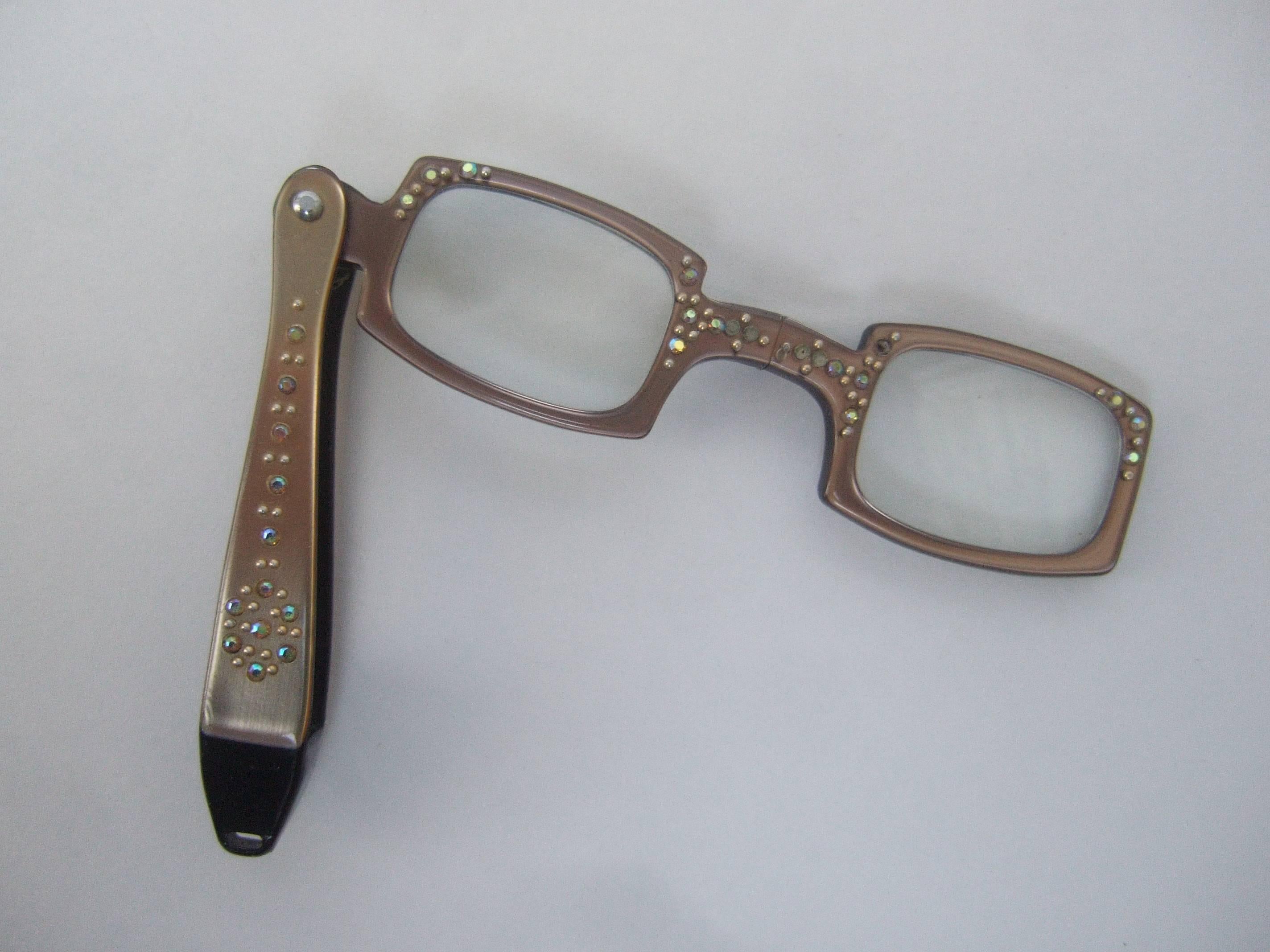 Opulent lucite crystal embellished diminutive opera glasses
The elegant tiny opera glasses are embellished
with sprinkles of glittering crystals embedded on 
the bronze lucite frame

The tiny eye glasses make a charming accessory
for the opera