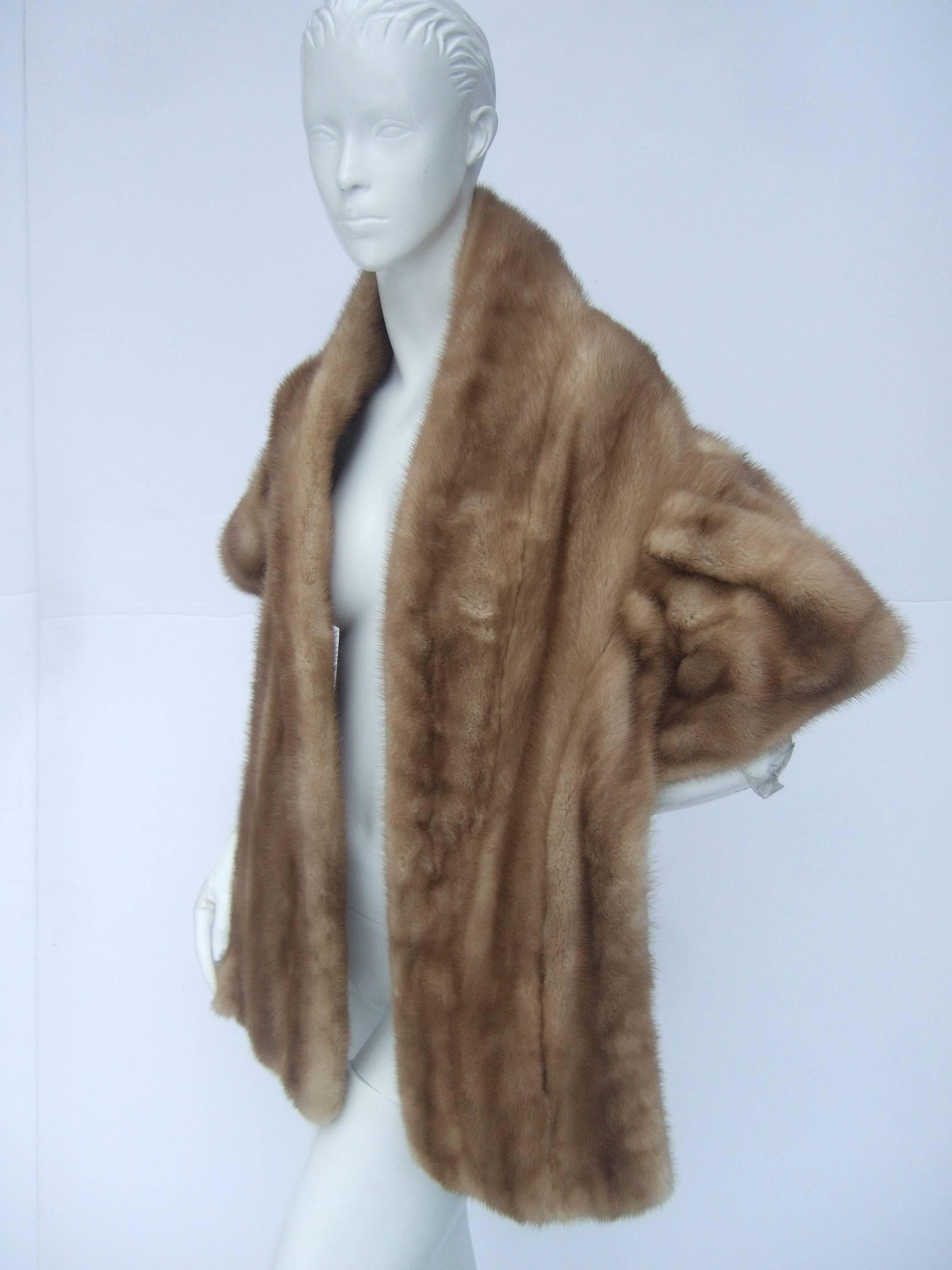 Opulent autumn haze plush mink fur stole ca 1960s
The stylish retro mink fur stole is designed 
with luxurious light brown mink fur

The back side is designed with an unique 
ruched panel that runs across the back
and extends to the capped