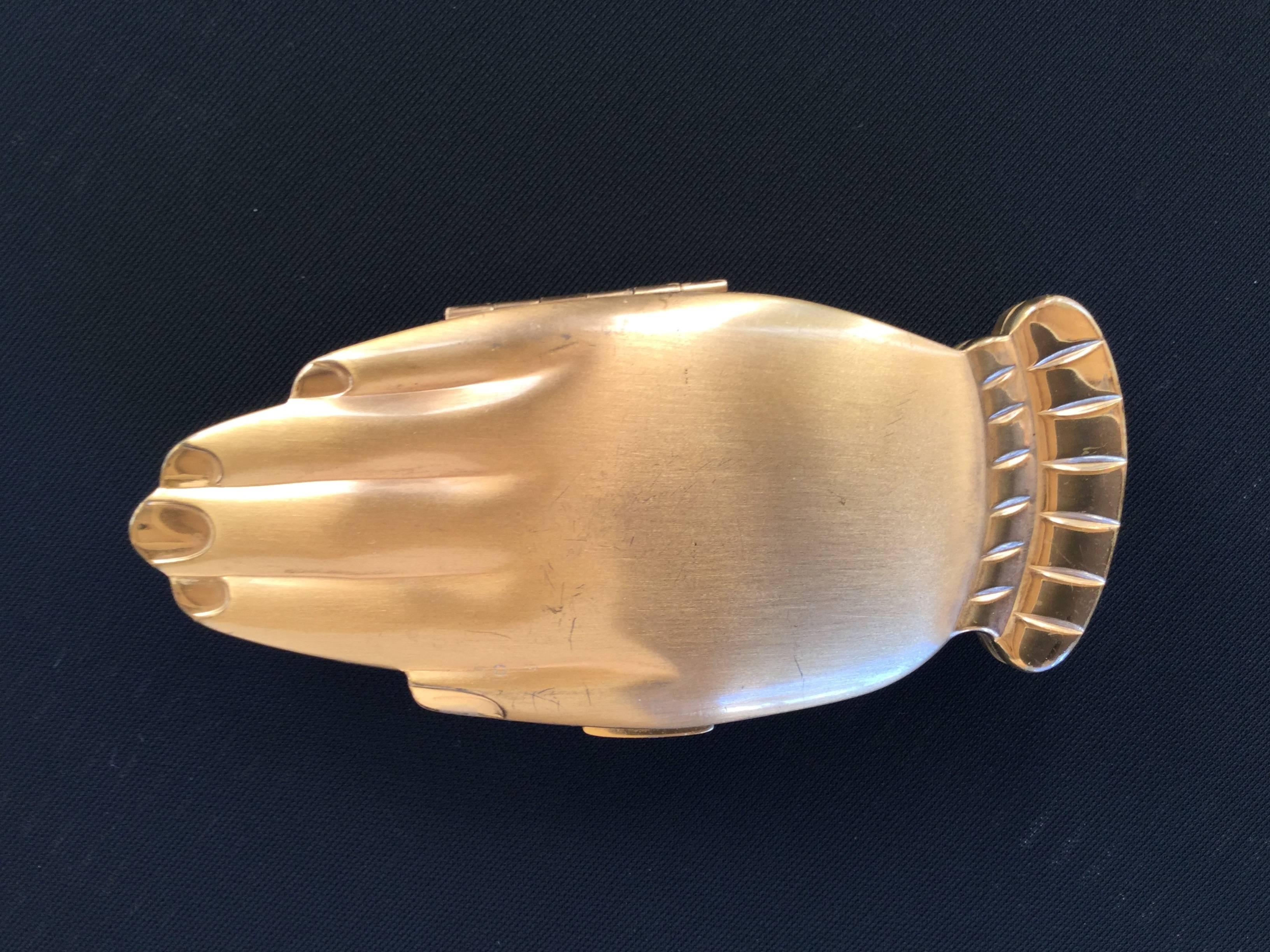 
This is one of the most iconic and sought after of all vintage figural
compacts.

The Volupte "Golden Gesture" compact depicts two slender,
manicured hands clasped as if in prayer. 

The design is just magical.

There is