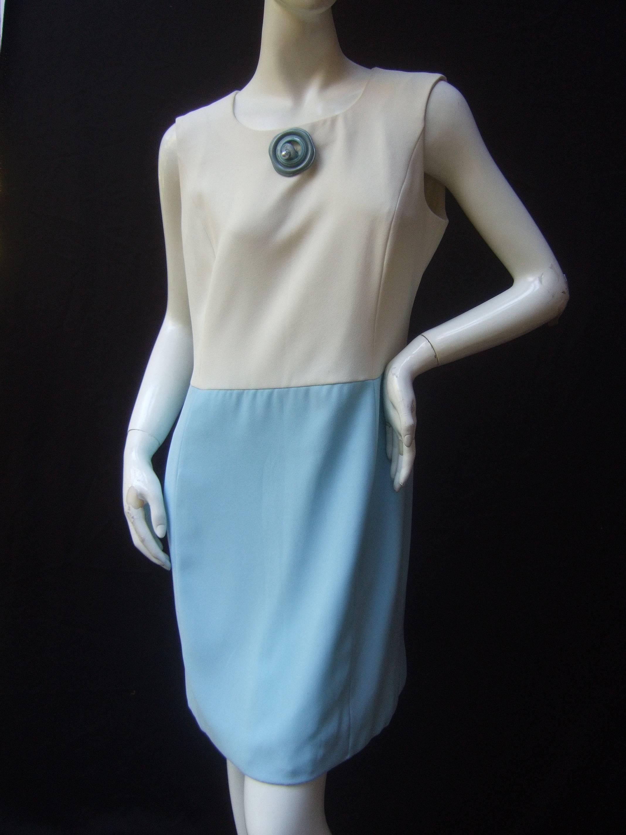 Pierre Cardin Mod white & turquoise sheath dress 
The chic retro designer dress is designed with a white 
shell top combined with a pale aqua blue 
skirt section 

The neckline is adorned with a large pale blue lucite
circular mock button