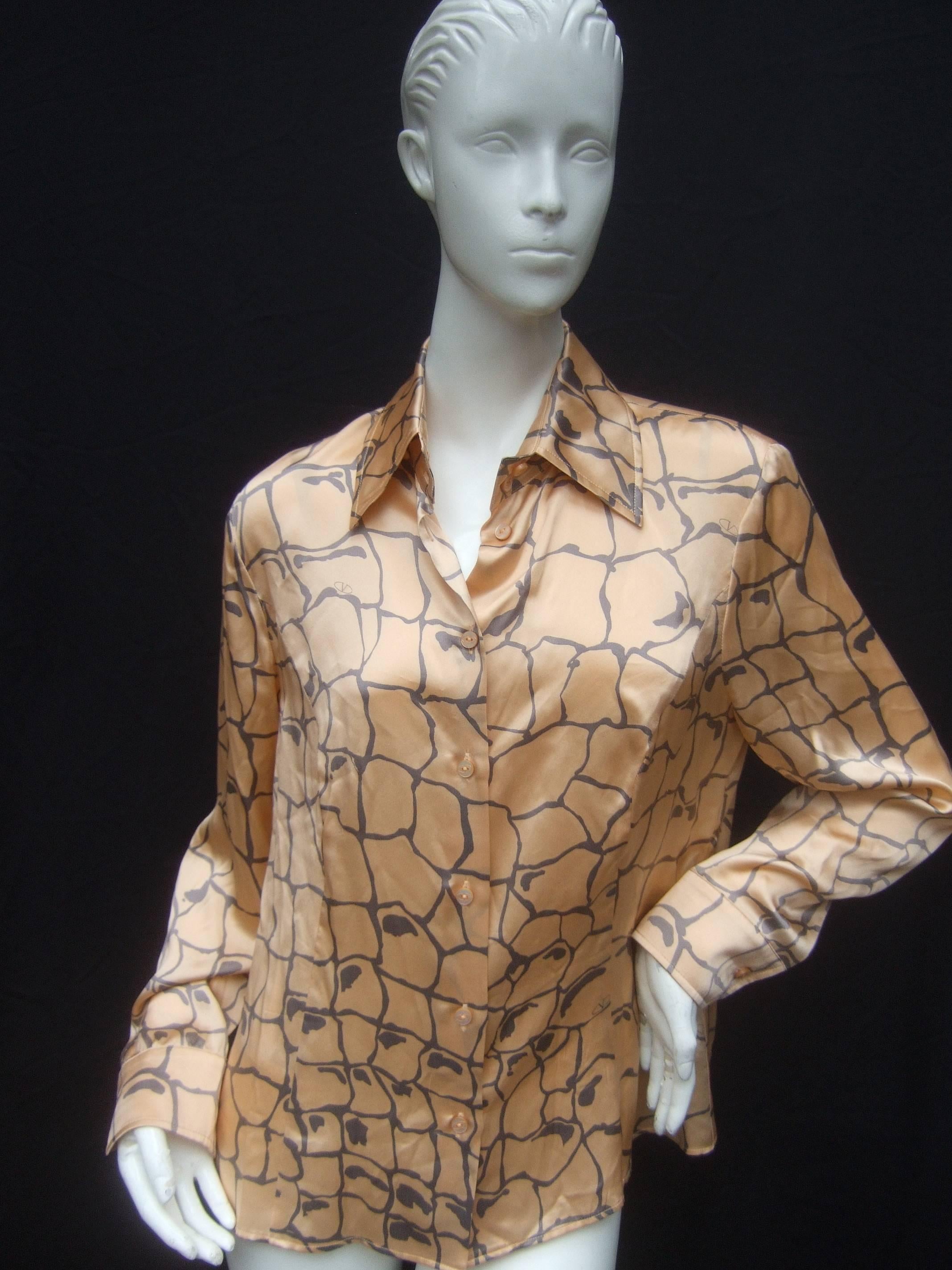 Valentino Silk charmeuse peach and gray print blouse 
The elegant Italian blouse is designed with luminous 
peach color silk with streaks of gray silk graphics

Valentino's V initial is repeated throughout the print
Accented with small mother