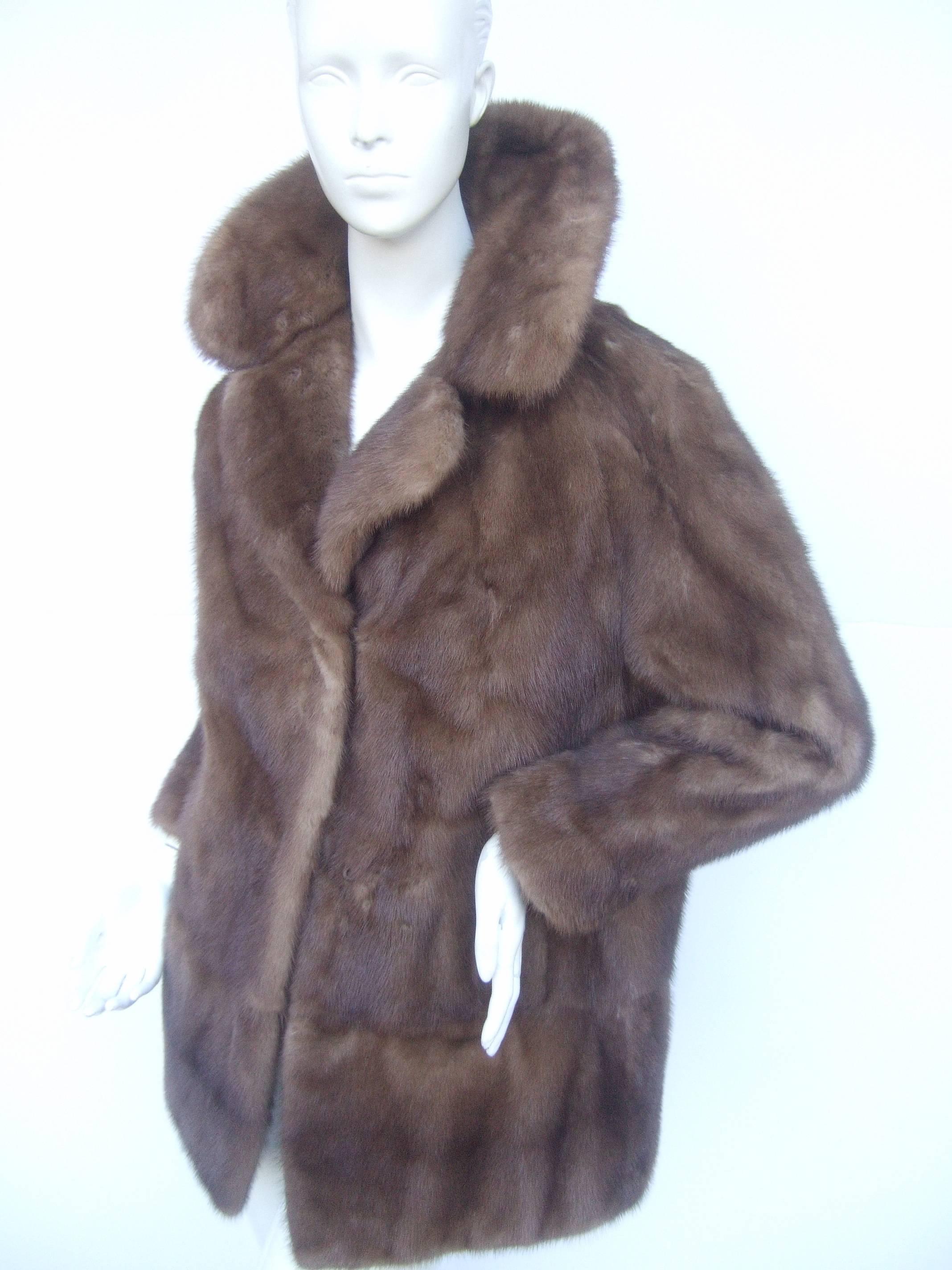Luxurious plush autumn haze mink fur jacket
The elegant mink fur jacket is designed
with medium brown sumptuous mink fur

The lower hemline has an eight inch panel 
that circles around the bottom of the jacket 

The wide dramatic collar can
