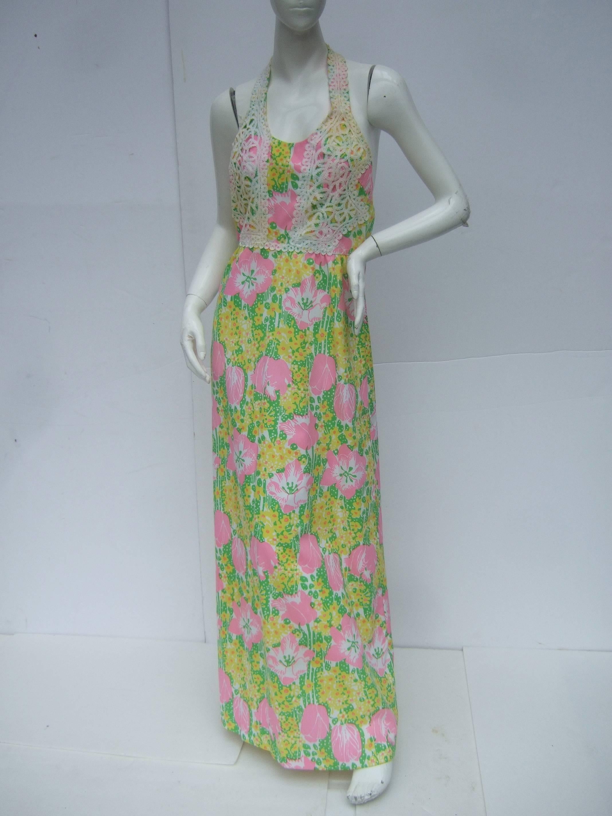 Lilly Pulitzer Vibrant floral print halter gown c 1970s
The crisp cotton blend backless gown is designed 
with a field of lush flower blooms that range
from cotton candy pink to buttercup yellow

Interspersed within the bold color