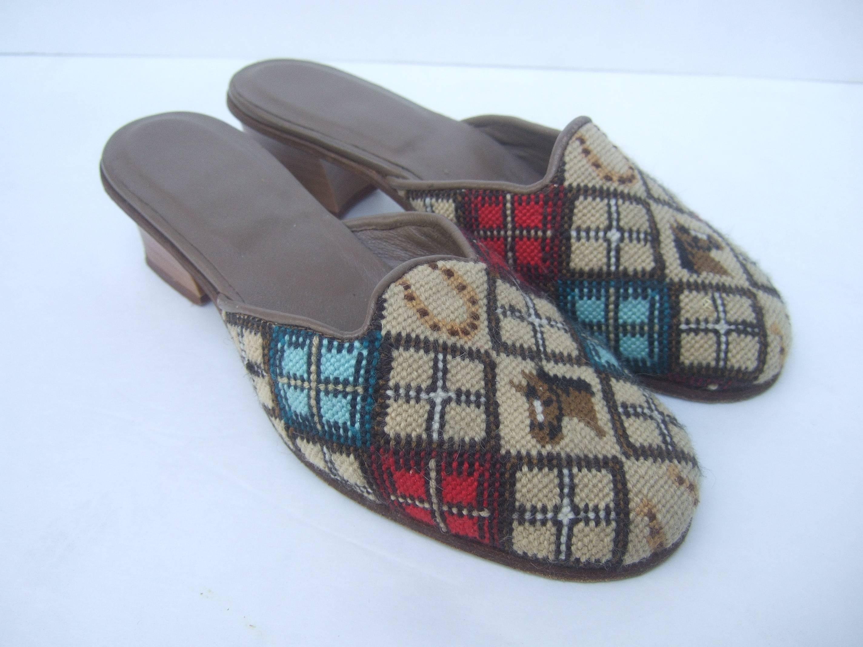 Charming needlepoint equine slipper shoes Made in Italy 
The unique needlepoint shoes are designed
with horse heads and horse shoe figures

Accented with geometric designs interspersed
with the horse head and horse shoe figures

The interior