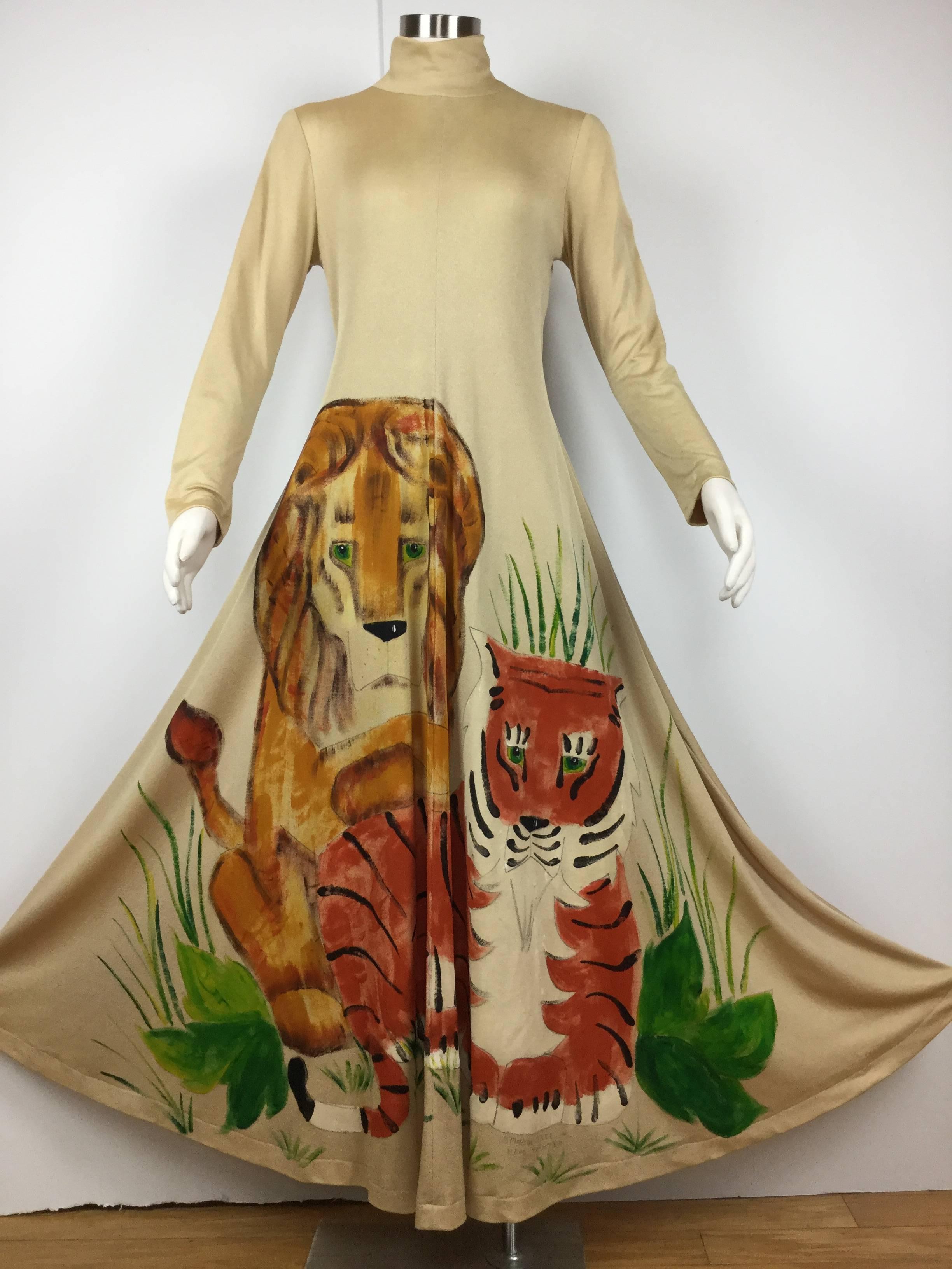 
Wow!  This dress is just amazing.  So unique.

Made of slinky gold metallic polyester with hand painted portraits of
a lion and a tiger posing in a burst of jungle foliage.

The big cats' faces are incredibly expressive.

Made in the 1970's