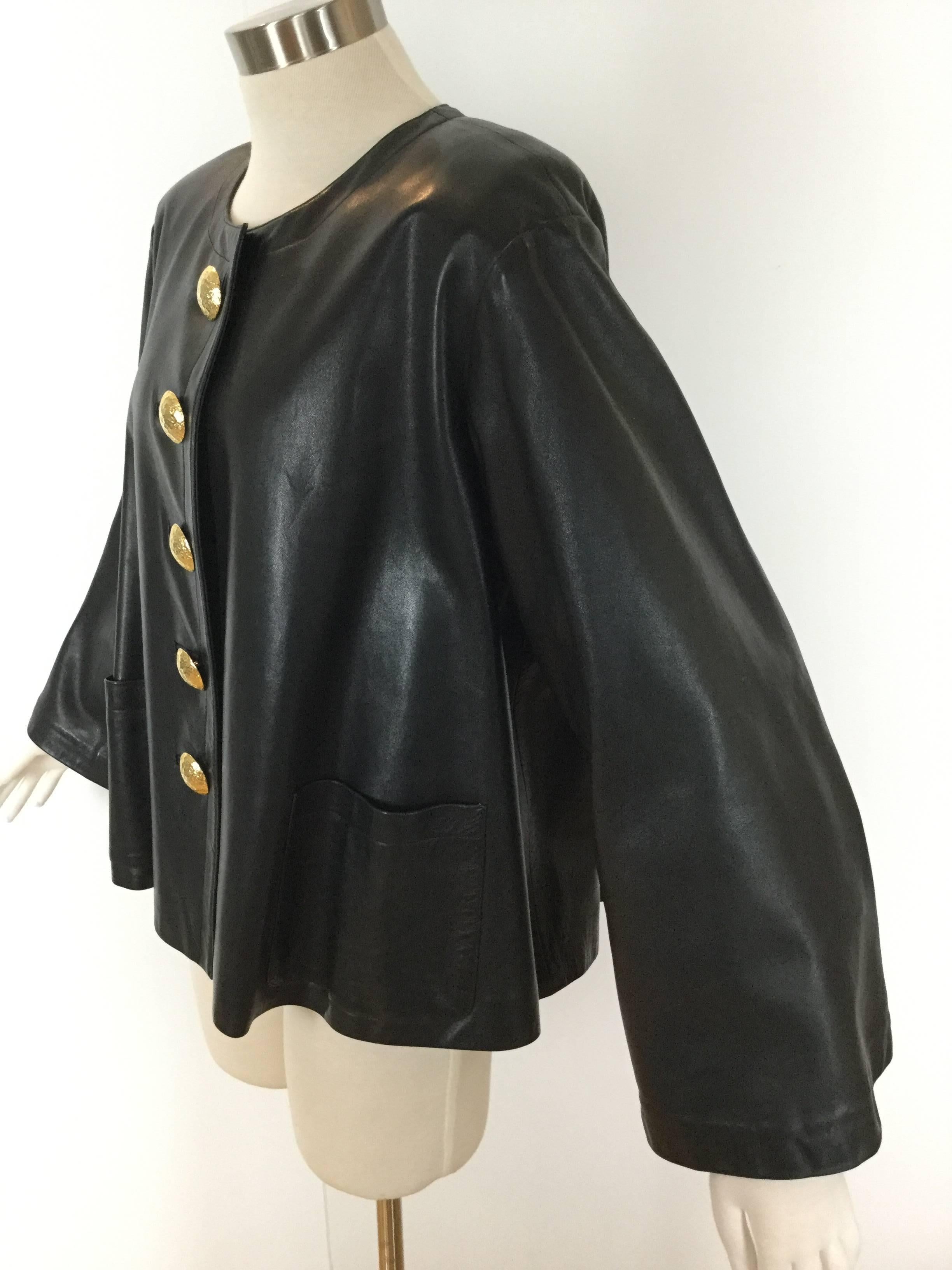 
Wonderful Yves Saint Laurent Rive Gauche jacket in butter soft black leather.

This flaring swing style cut is incredibly flattering to wear.

Amazing bell sleeves are 8.5 inches wide at the bottom.

Huge, gorgeous gilt metal buttons