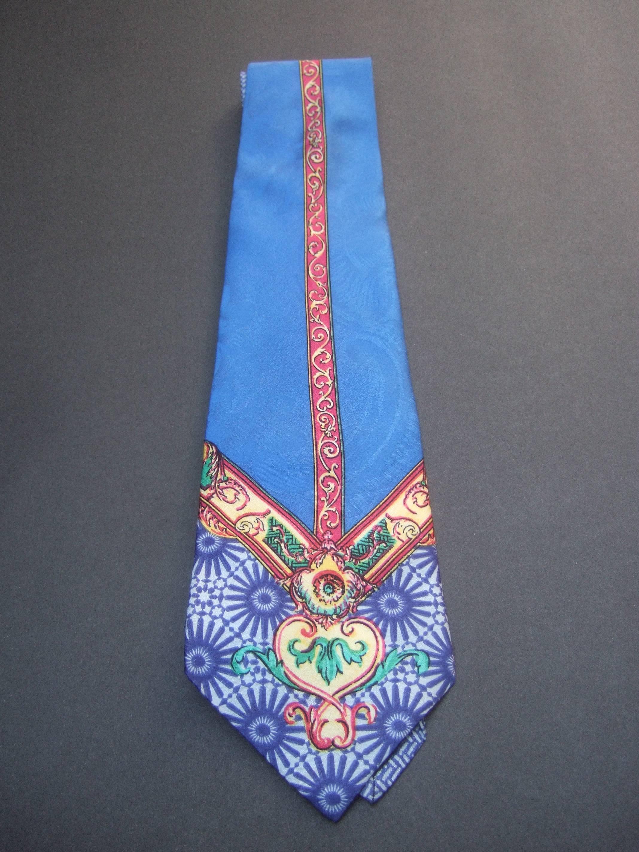 Versace Vibrant silk graphic print necktie 
The high fashion necktie is illustrated 
with lapis blue combined with scrolled
golden accents 

Epitomizes Versace's signature bold
eye catching prints

Labeled Gianni Versace 

The widest