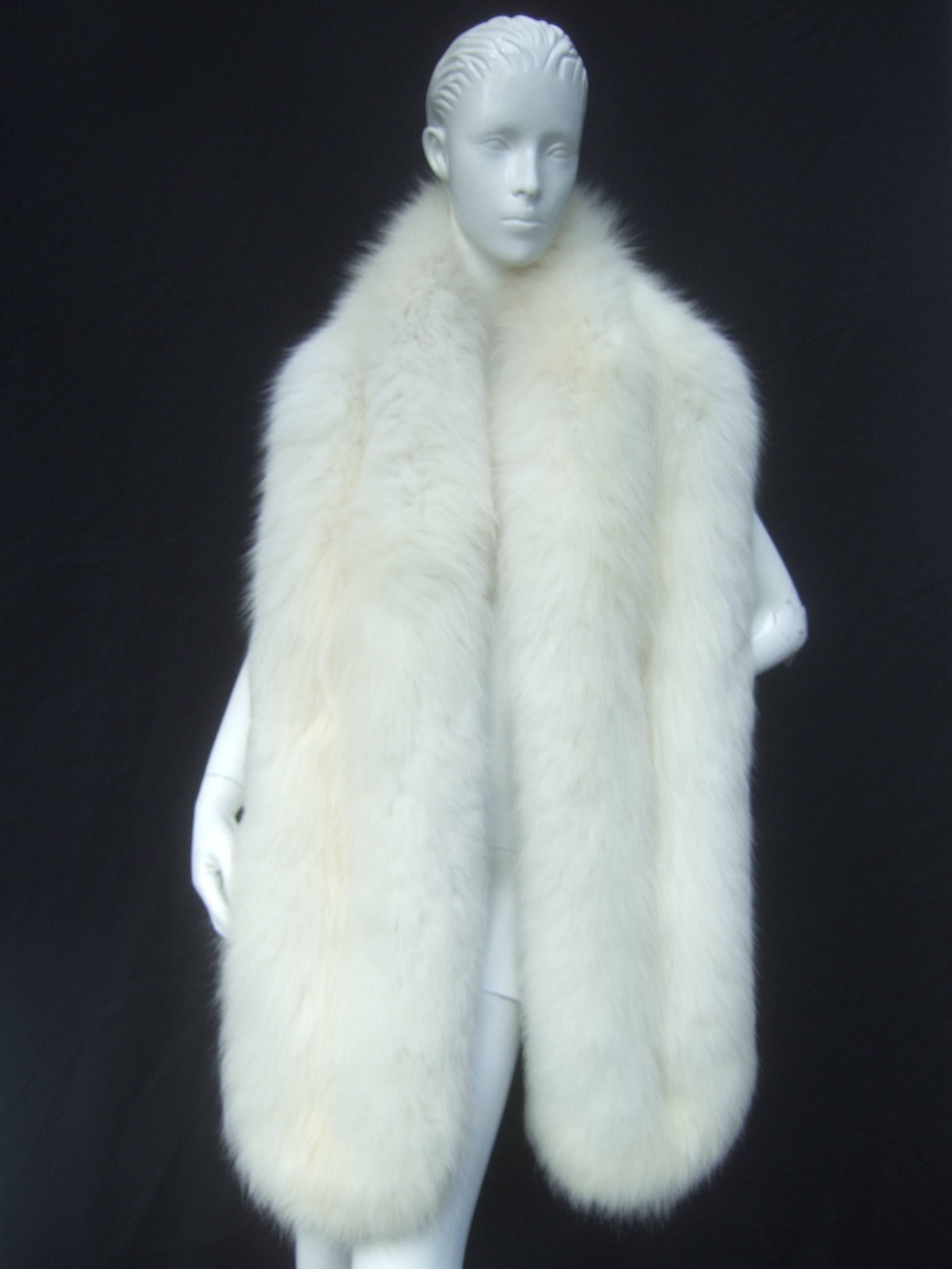 Opulent long plush fox fur wrap c 1970 
The luxurious fox wrap can be worn 
in various styles due to the long length 

The sumptuous fluffy fox fur is designed
with two long panels. Lined in white satin
with two small pockets to place one