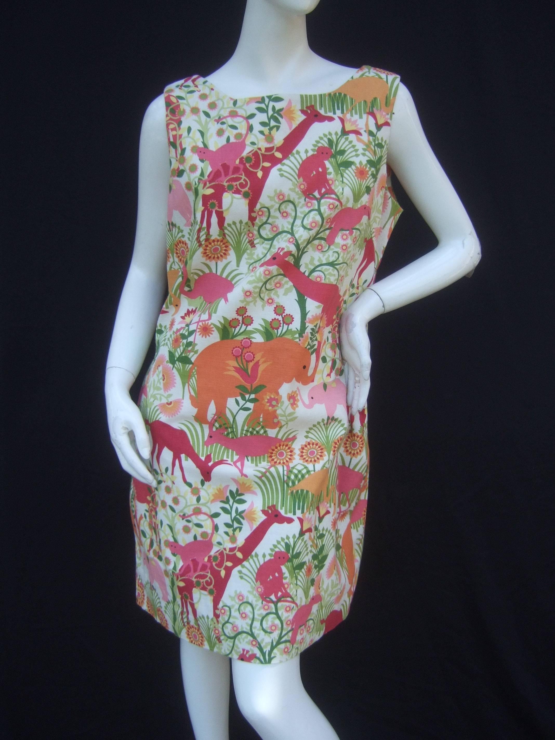 Charming jungle print cotton sheath dress
The fun summer sheath is illustrated with
a menagerie of exotic wild animals; monkeys,
elephants, giraffes, wading birds, and gazelles 

The collection of animals are exploring in a 
jungle paradise