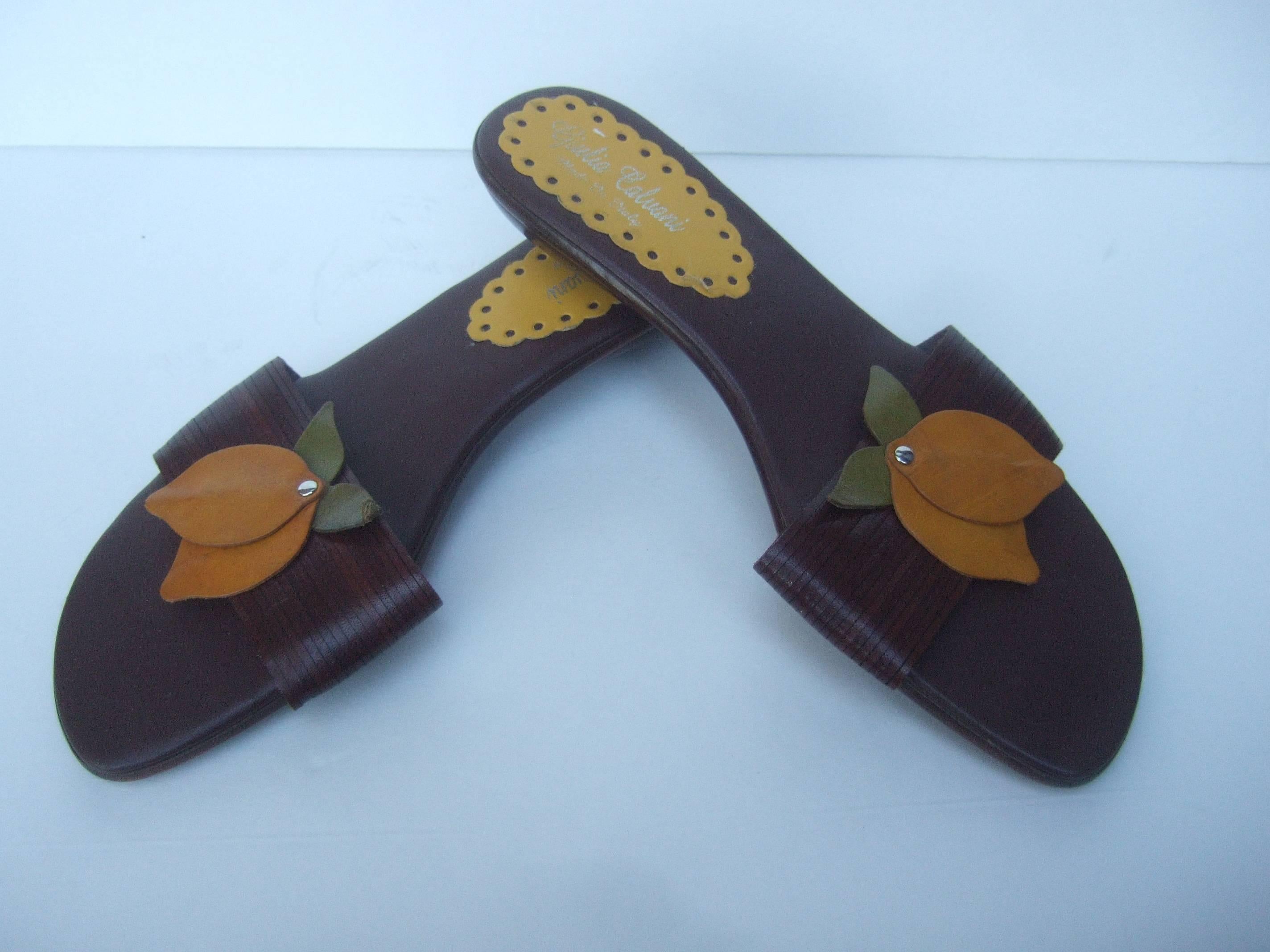 Stylish Italian leather applique lemon sandals 
The whimsical Italian sandals are designed
with a pair of applique leather lemons 
and leaves on the front 

The leather lemons are secured to a 
wide brown leather panel designed
with rows of