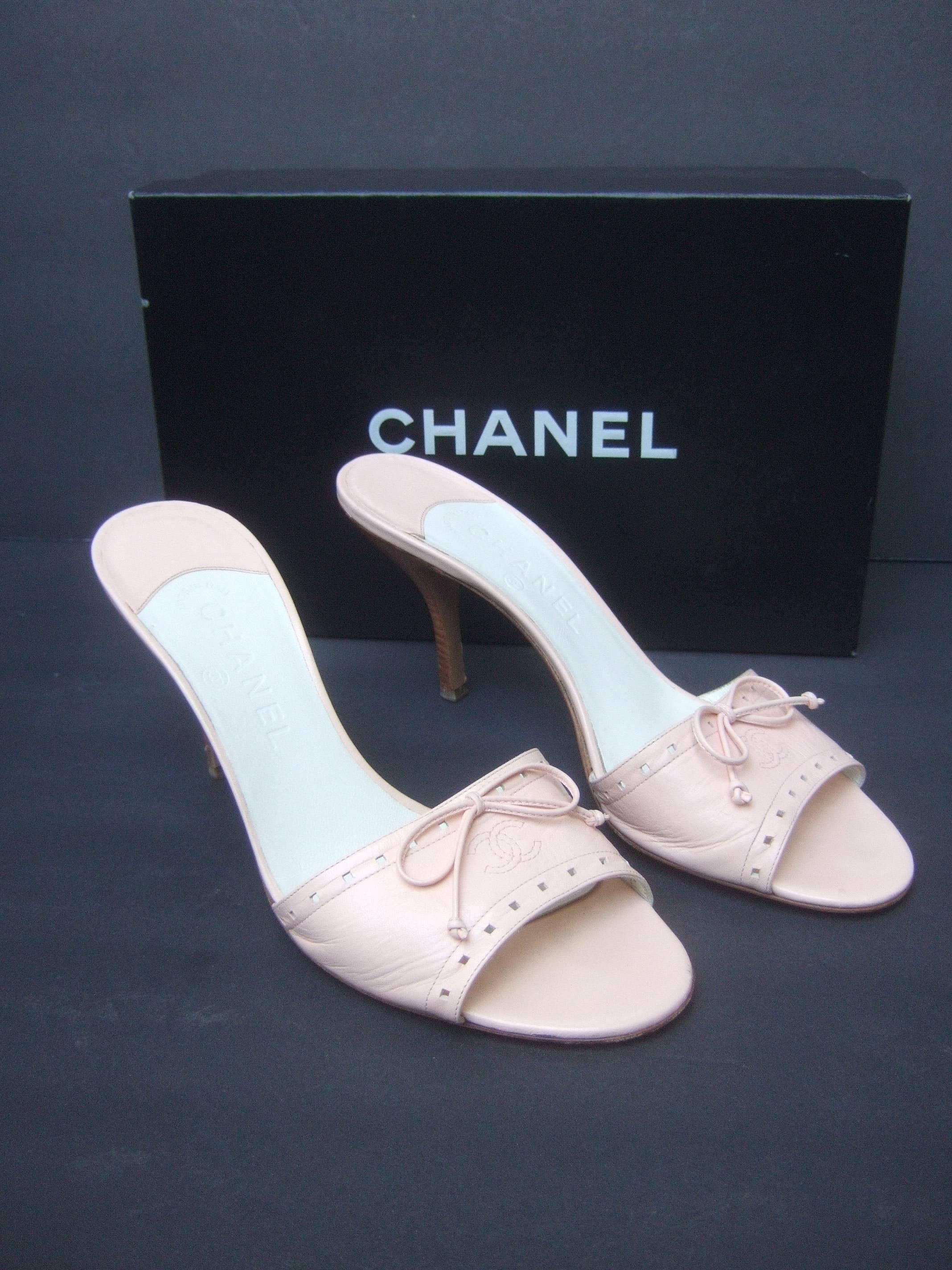 Chanel Classic pale pink leather mules in Chanel box
The stylish Italian pumps are designed with Chanel's
interlocked stitched initials on the front with a bow

The borders of the leather band are accented with 
perforated detail. The interior