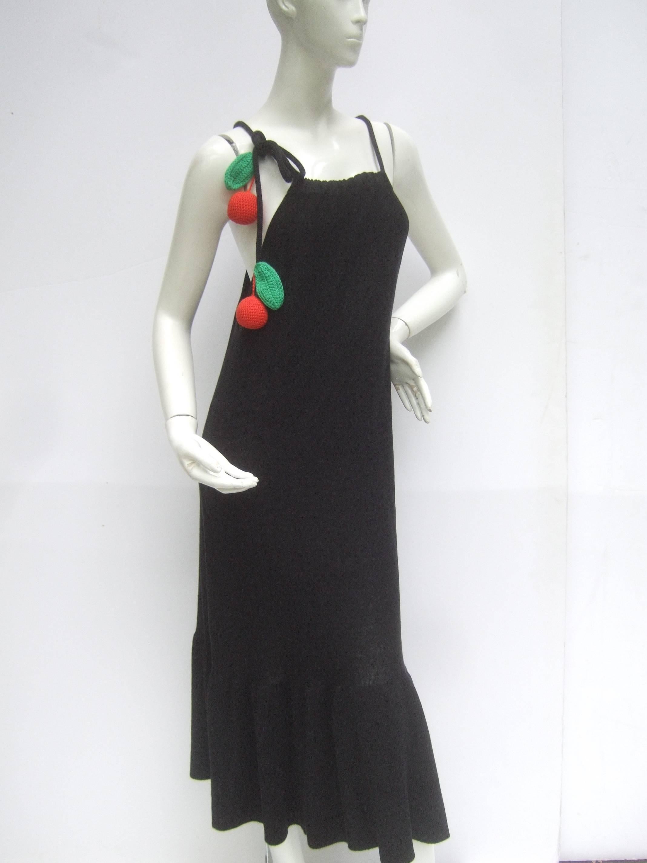 Sonia Rykiel Unique black cotton knit long dress
The cotton knit column style dress is designed
with a pair of whimsical large red knit cherries 
and matching green knit leaves

The dangling knit fruit is suspended from
one of the cotton rope