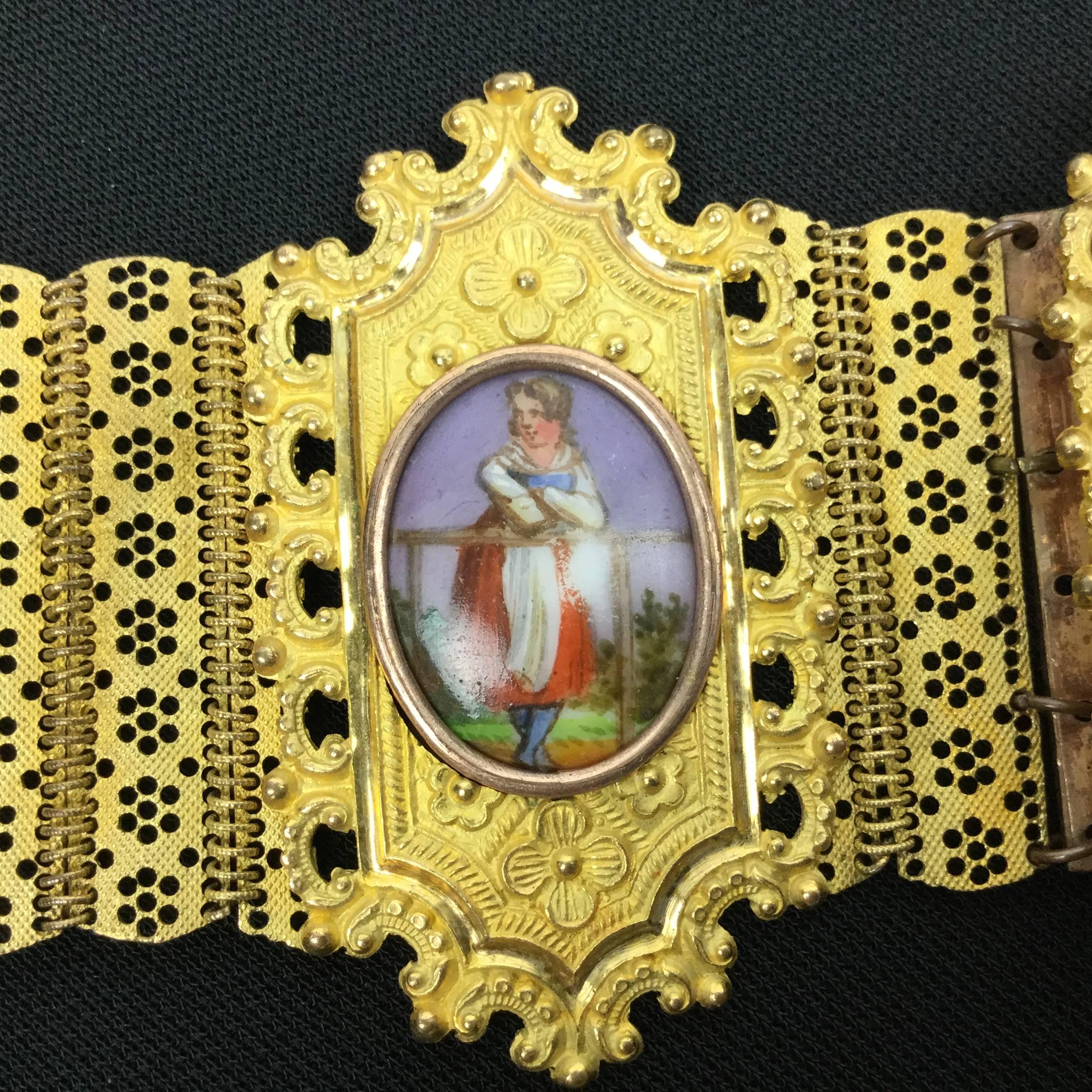 Incredibly detailed antique Georgian bracelet made of Pinchbeck with four 
hand painted porcelain portraits framed and inset on elaborately decorated
panels.

Pastoral Themed. So romantic!

Wafer thin panels connected by multiple links.