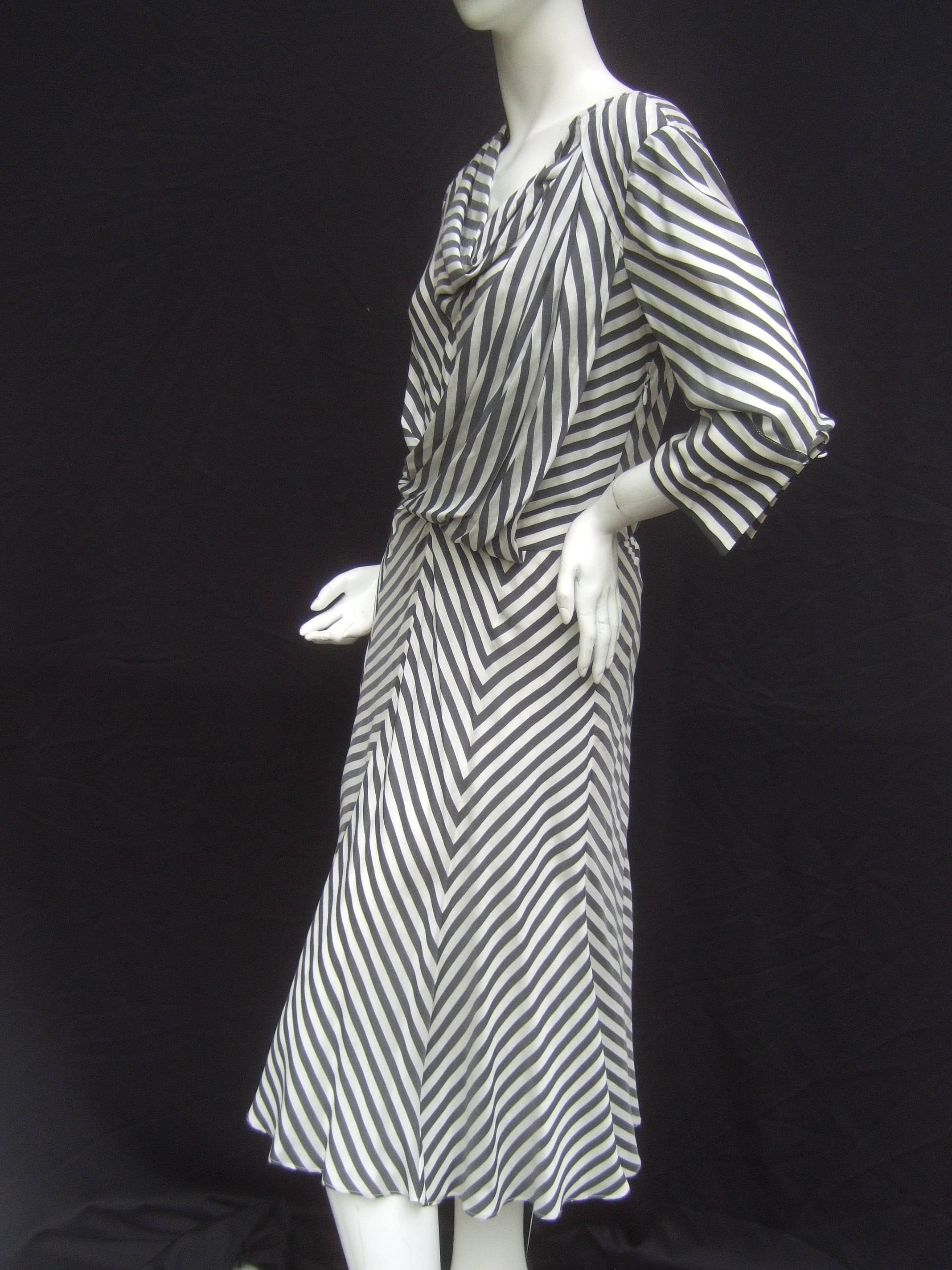 Les Copains Crisp silk chevron striped dress Size 42
The chic Italian silk dress is designed with bold
gray and white stripes in contrasting patterns  

The bodice and neckline have a draped pleated detail
The chevron pattern is designed with a