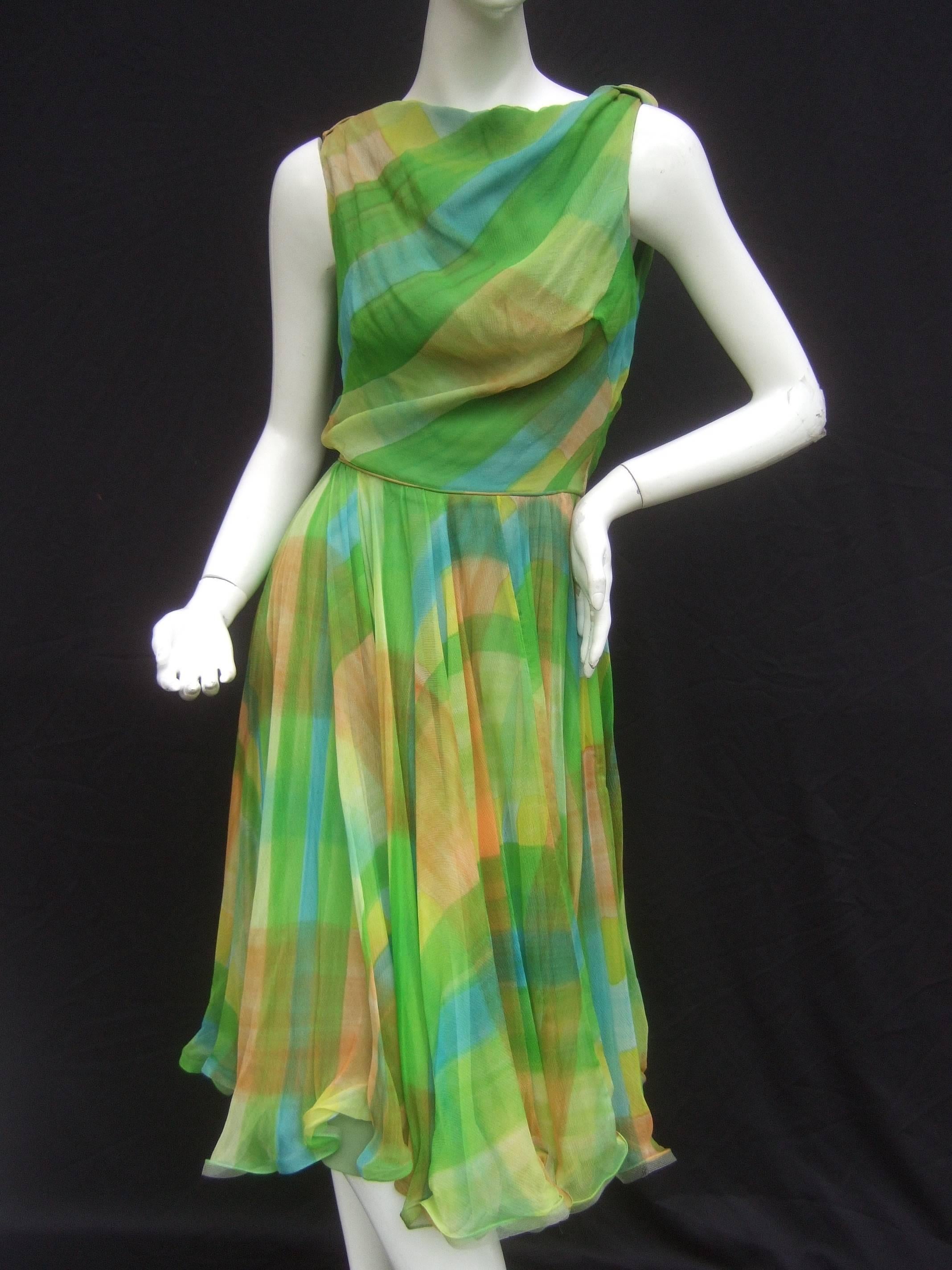 1960s Vibrant sheer silk chiffon swing dress ca 1960
The chic retro dress is a palette of citrus greens,
hints of golden yellow, with streaks of aqua blue
and smoky brown bands

The back side of the sleeveless bodice is designed
with sweeping