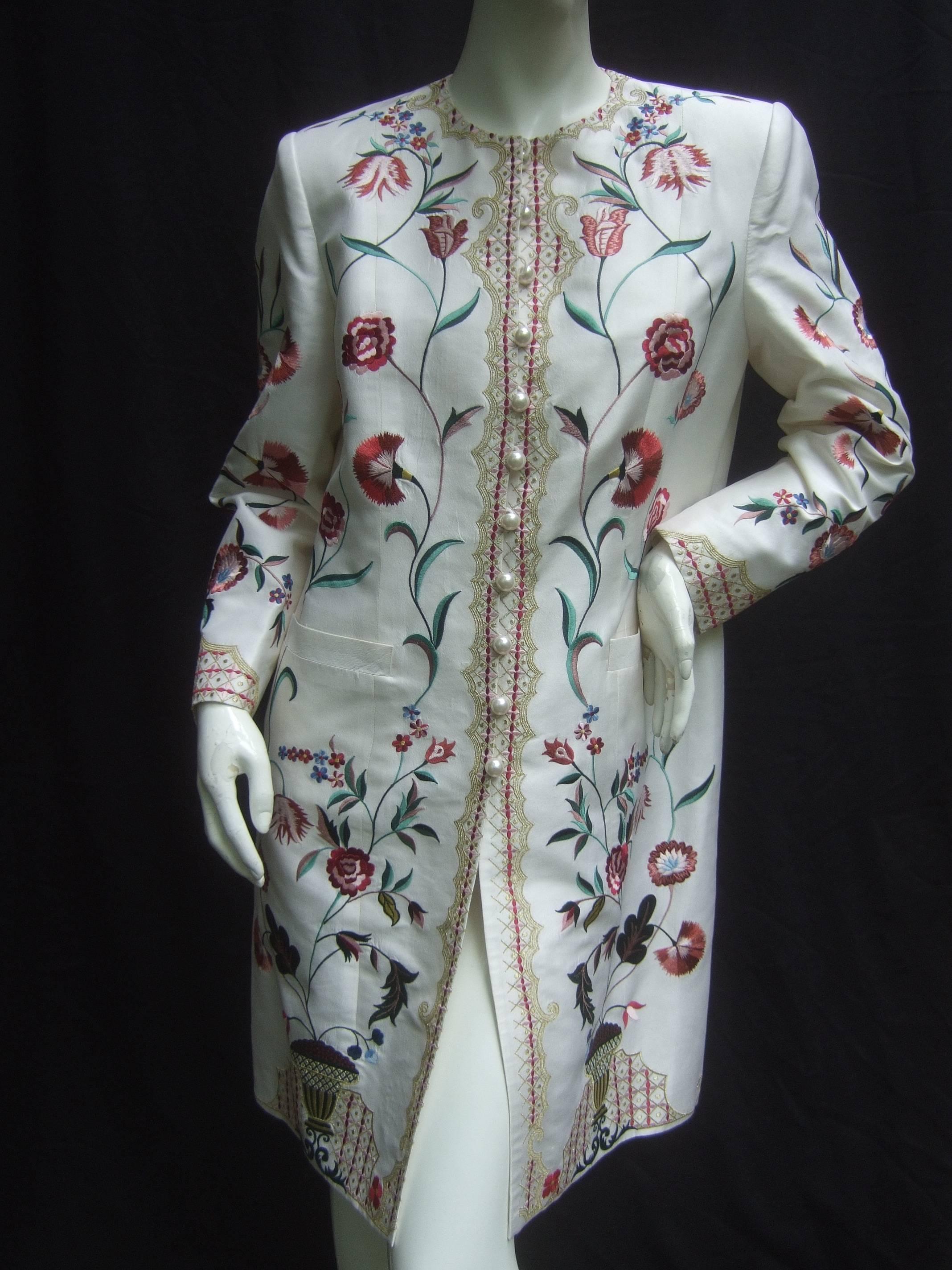 Exotic Haute couture embroidered satin coat by Max Nugus
The opulent coat is embellished with elaborate floral 
embroidery that has an Asian influence 

The duster style spring coat is adorned with resin
enamel pearl buttons that partially run