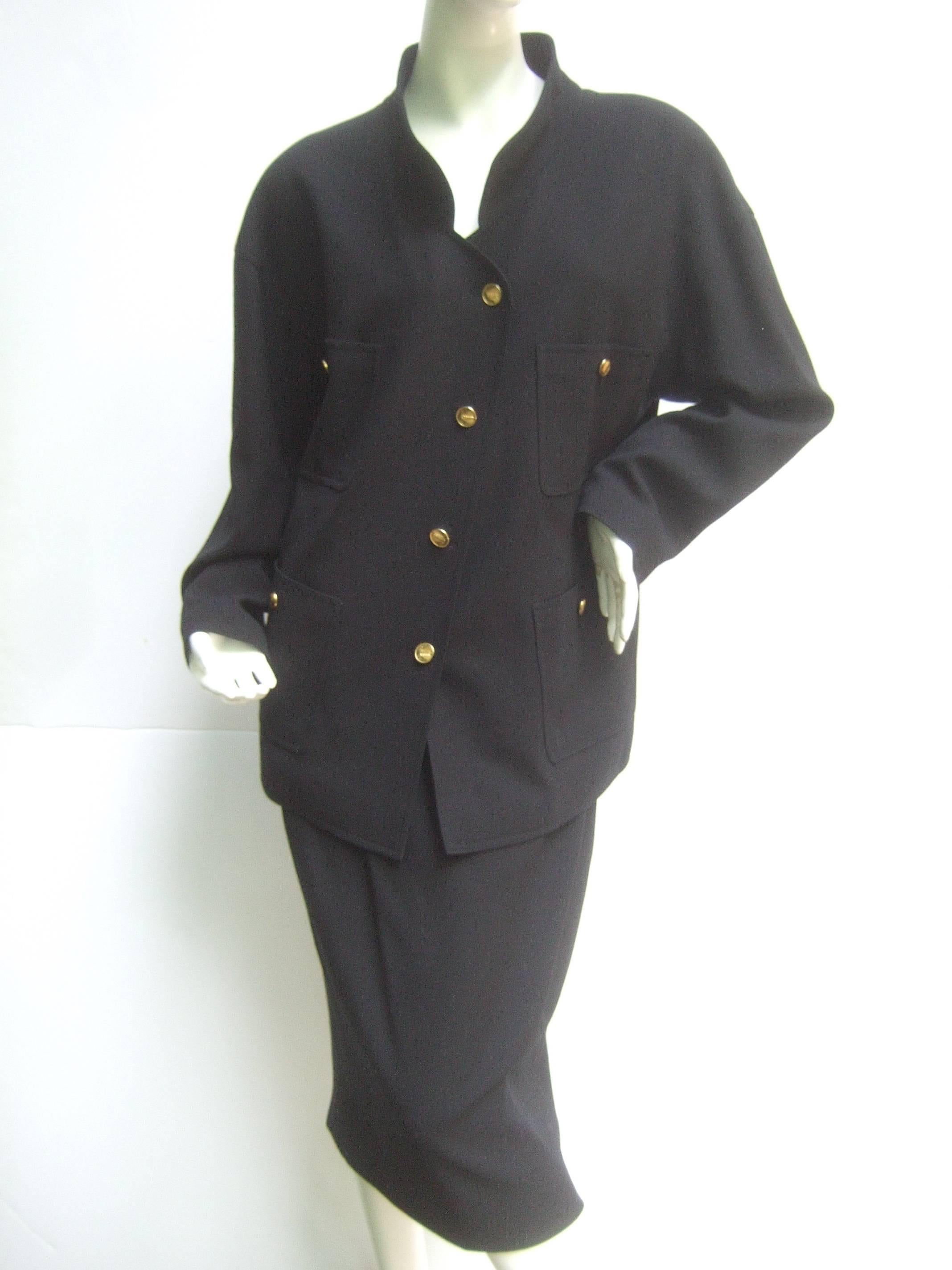 Chanel Classic black wool skirt suit ca 1990s
The stylish ensemble is designed with
light weight laine wool shell and is silk
lined

The chic jacket has a nehru style collar that 
has a military influence. The light weight wool 
jacket is adorned