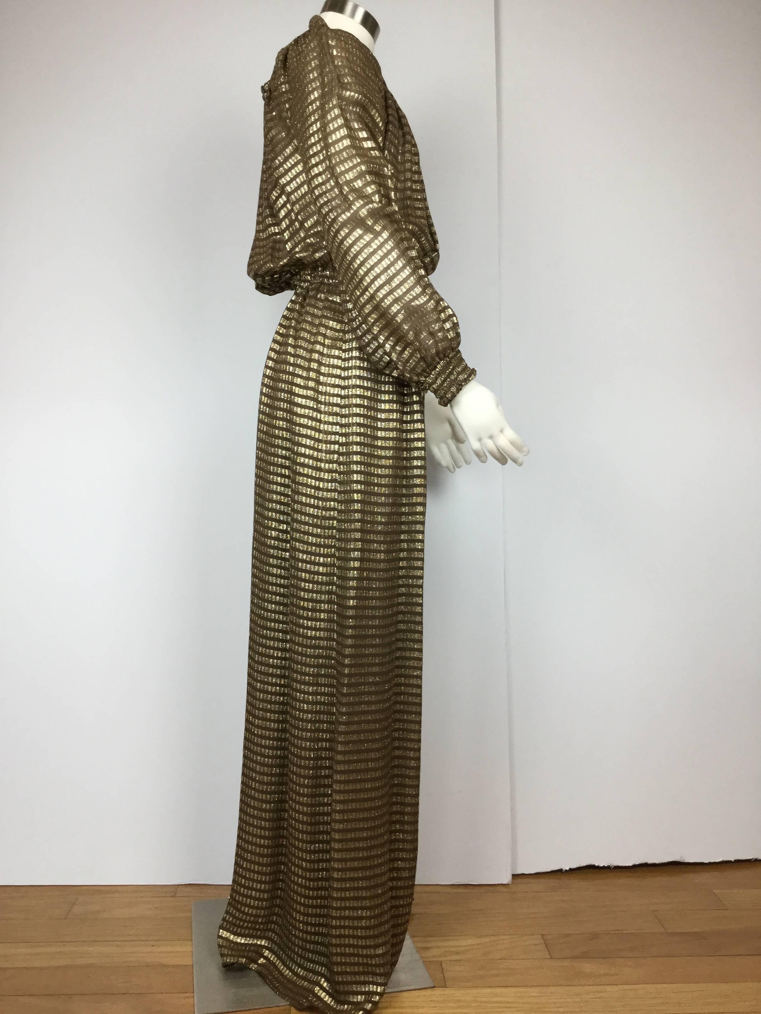 High impact late 1970's gold silk lame vintage column gown by Halston IV.  Great cut!  Really flows with you as you are walking. Open back. Slit skirt.  Shirring at wrists emphasizes the full sleeves. Shirred elastic at the waist creates a subtle