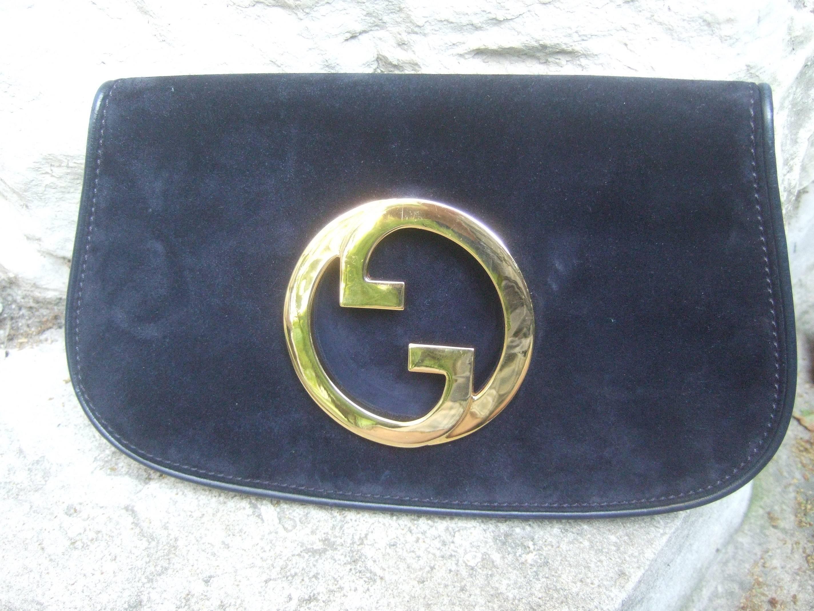 GUCCI Italy rare midnight blue suede clutch bag c 1970s
The chic clutch is covered with sumptuous plush
doeskin suede

The Italian suede clutch is adorned with Gucci's 
sleek massive gilt metal interlocked initials 
The edges are framed with