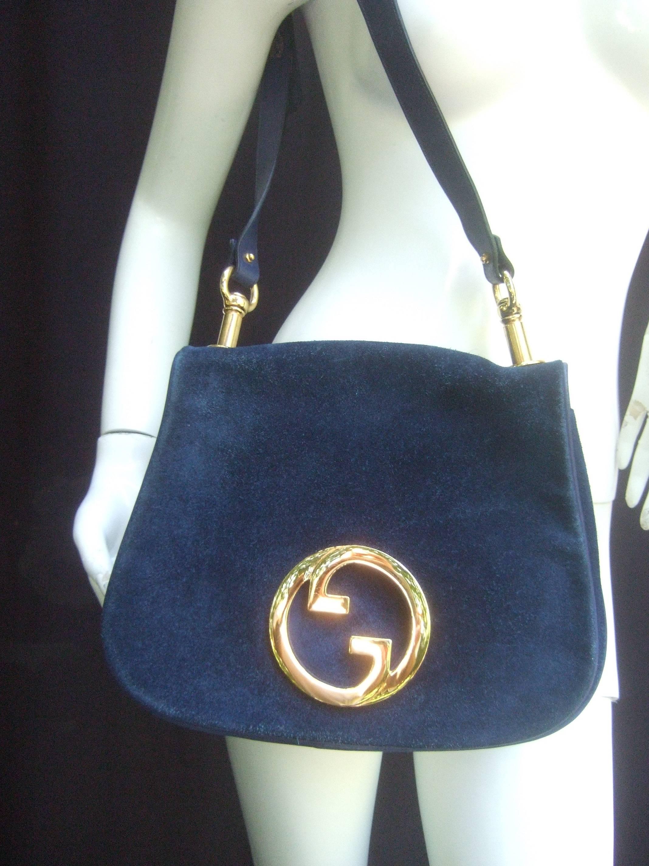 Gucci Italy Rare midnight blue suede shoulder bag c 1970s
The chic designer handbag is covered with luxurious 
blue doeskin suede

Adorned with Gucci's massive interlocked gilt metal
initials. The plush suede covering is accented with 
a blue