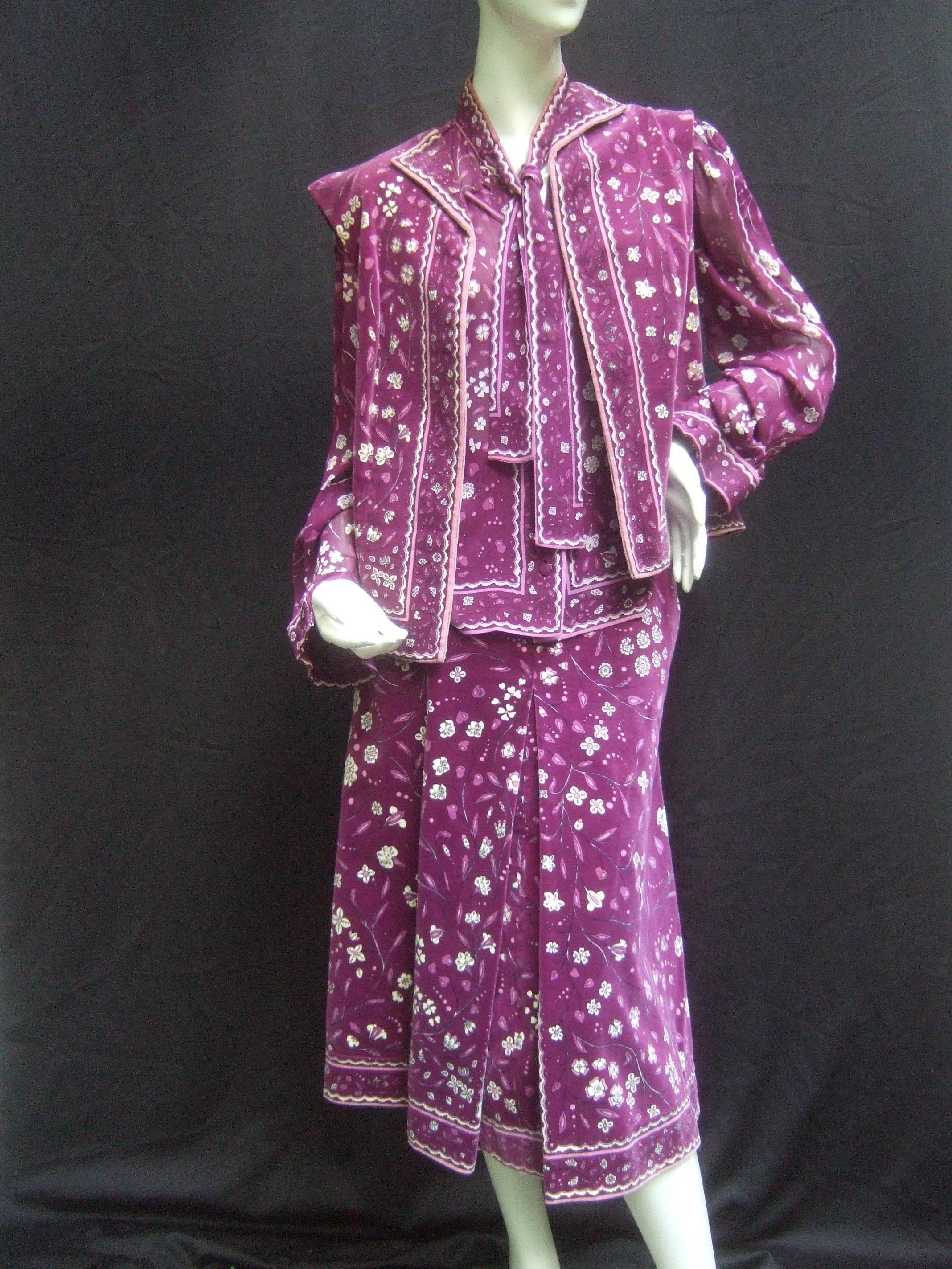 Emilio Pucci Purple floral silk & velvet ensemble c 1970
The stylish ensemble is designed with a cotton velvet
vest & matching velvet print skirt 

The sheer silk crepe blouse has the floral print graphics 
The sheer blouse has a built in
