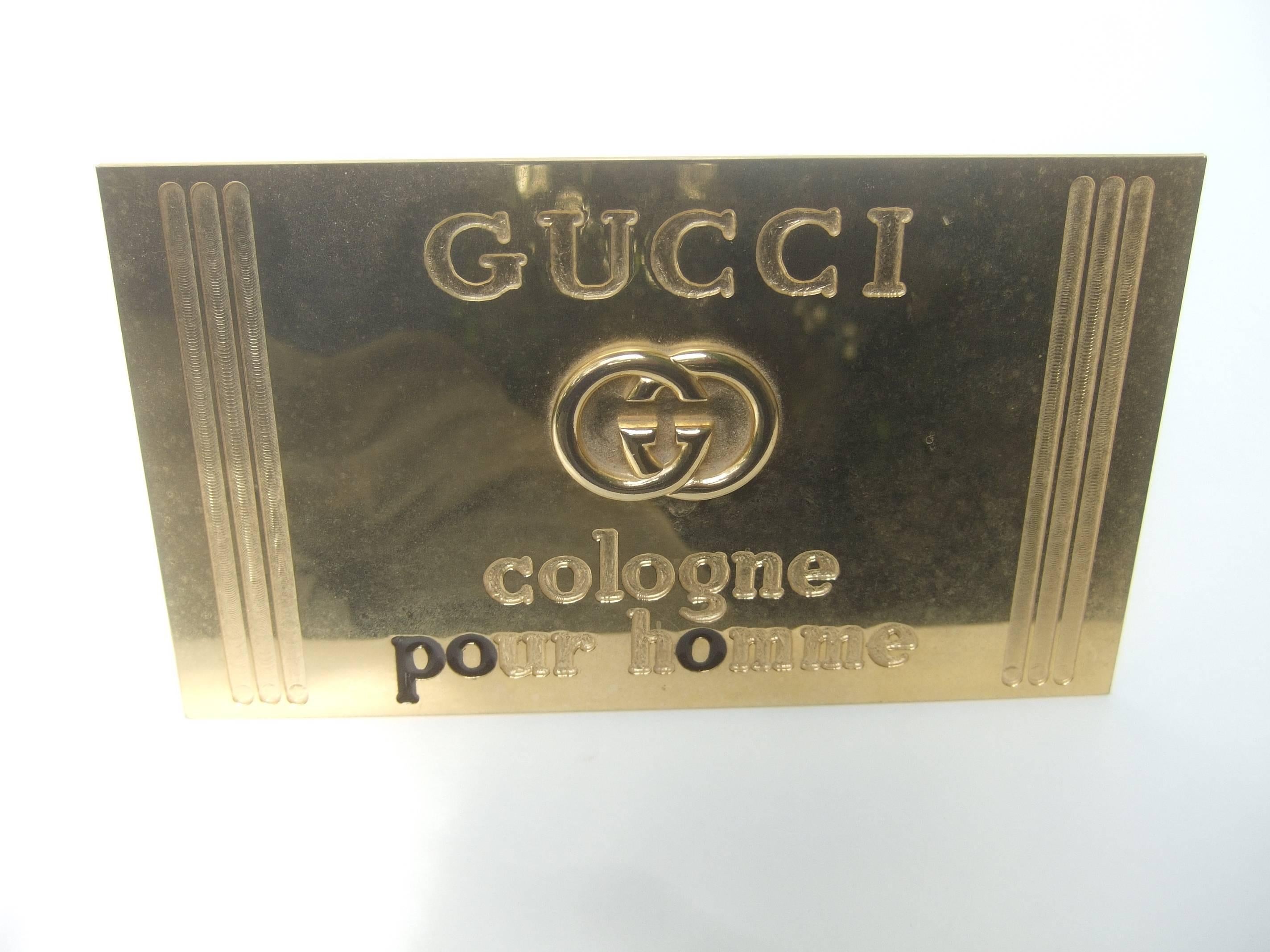 Gucci Italy Brass metal display sign c 1980s
The sleek brass metal sign was a display 
fixture at a Gucci Boutique retail store from
the men's fragrance department 

The sign is inscribed: Gucci cologne pour homme

The rare Gucci sign makes a