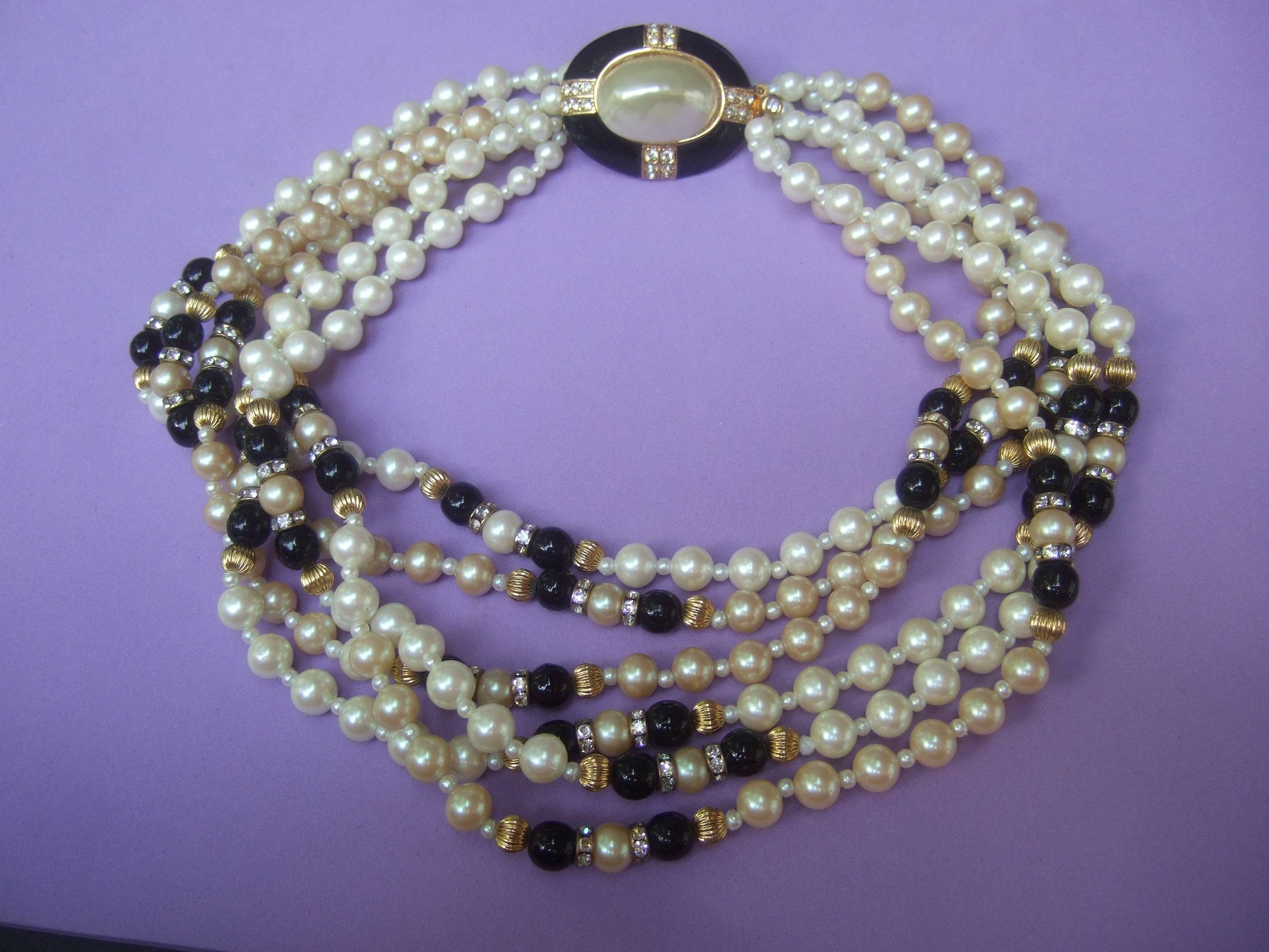 Elegant glass enamel pearl choker necklace 
The opulent costume necklace is designed 
with six rows of lustrous glass enamel pearls 

Interspersed within the rows of glass pearls
are round black glass beads accented with 
glittering diamante