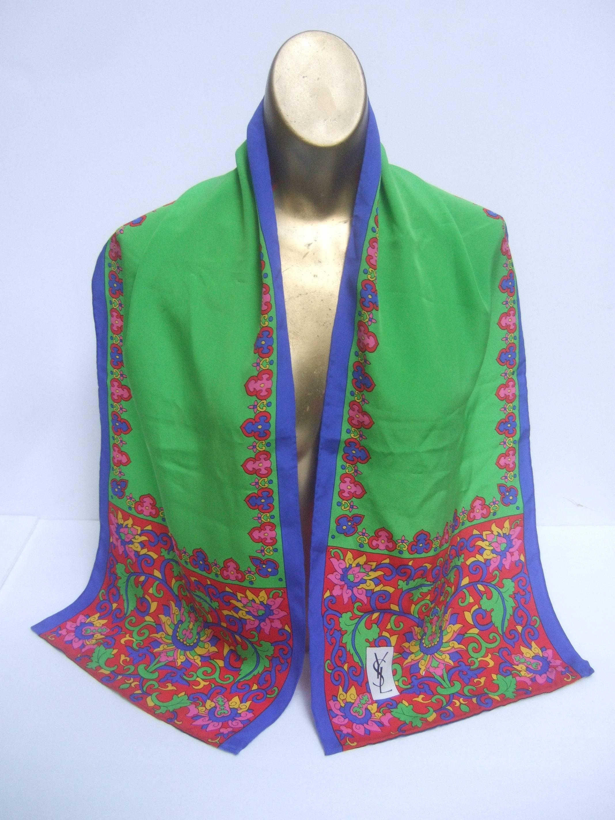 Yves Saint Laurent Silk oblong flower design scarf c 1990
The elegant silk hand rolled scarf is designed with a garden 
of flowers on both ends 

The bright green center panel is framed with a row
floral style graphics. The linear sides are