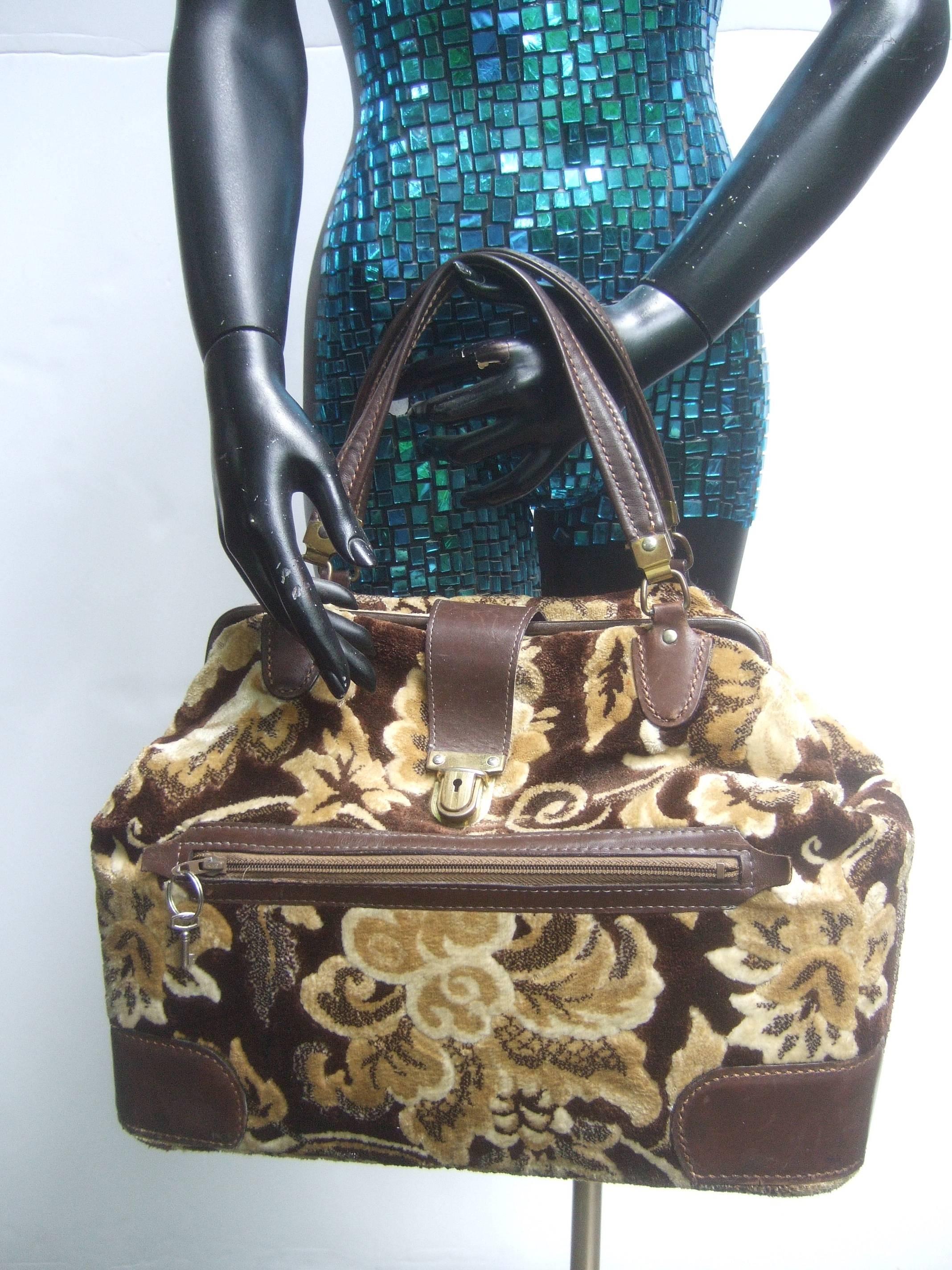 Stylish brocade leather trim travel case c 1970
The luxurious brocade travel case is covered
with autumn foliage in colors that range from 
brown, tan & beige

The twin handles, clasp frame and lower corners
are brown leather with saddle