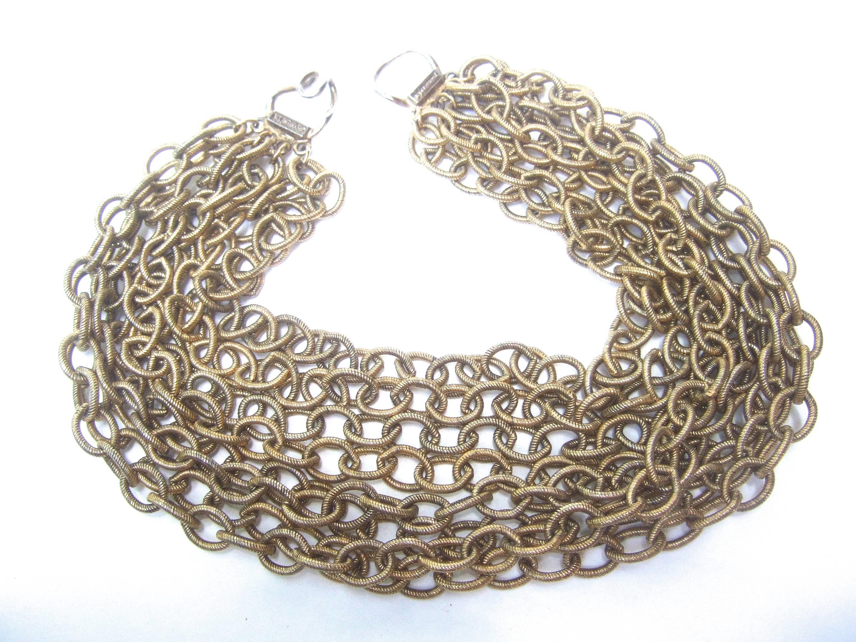 Bold gilt choker chain necklace designed by R J Graziano 
The stylish choker necklace is designed with eight rows
of heavy gauge wide oval link gilt metal chains 

The rows of gilt chains have a subtle grooved design  
with a matte gilt metal