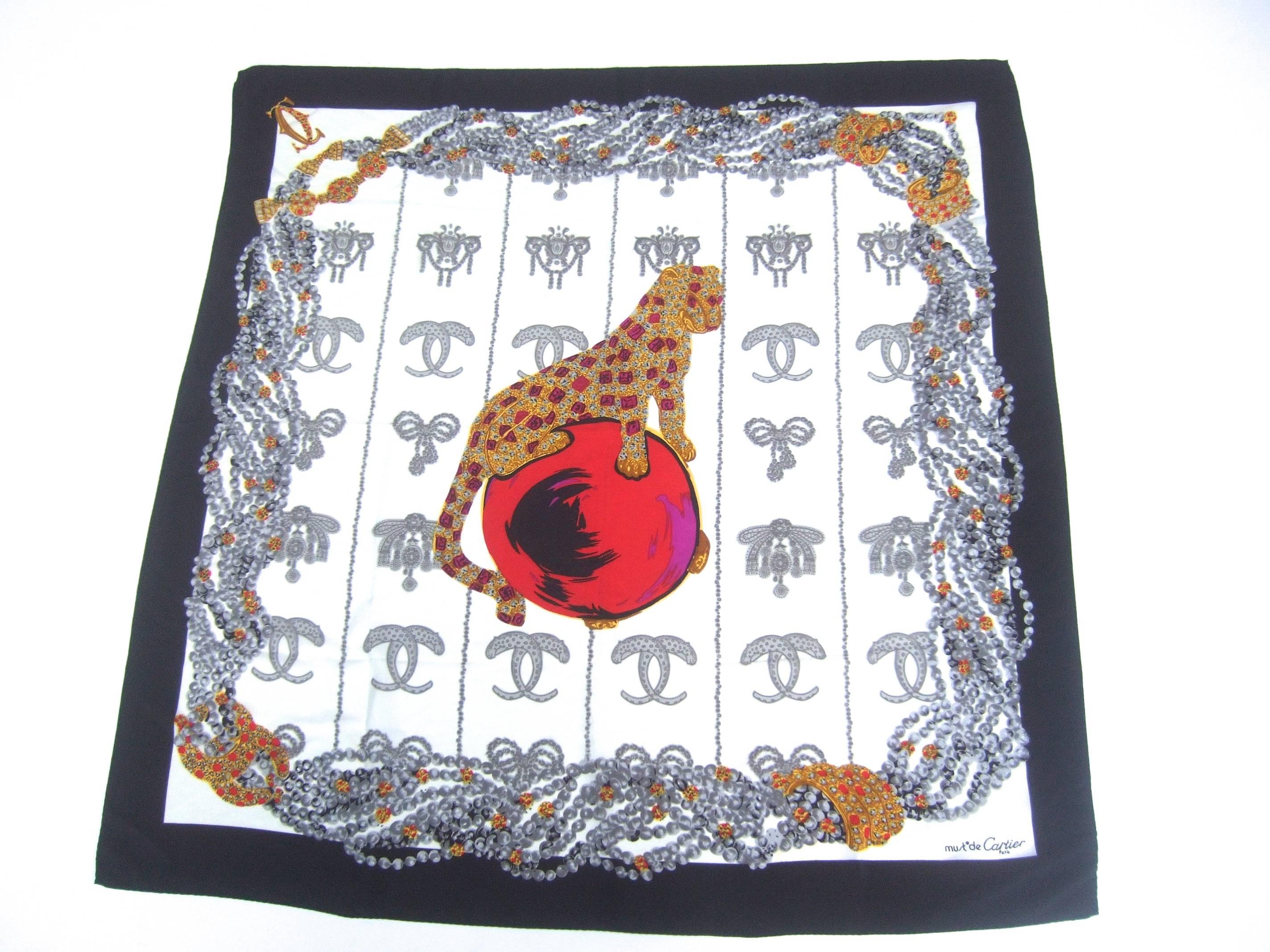 Cartier Paris Silk jeweled panther scarf c 1980s
The elegant designer scarf is illustrated 
with Cartier's iconic panther in the center

The panther is perched on top of a red jeweled 
orb. The bold graphics are designed with 
a series of