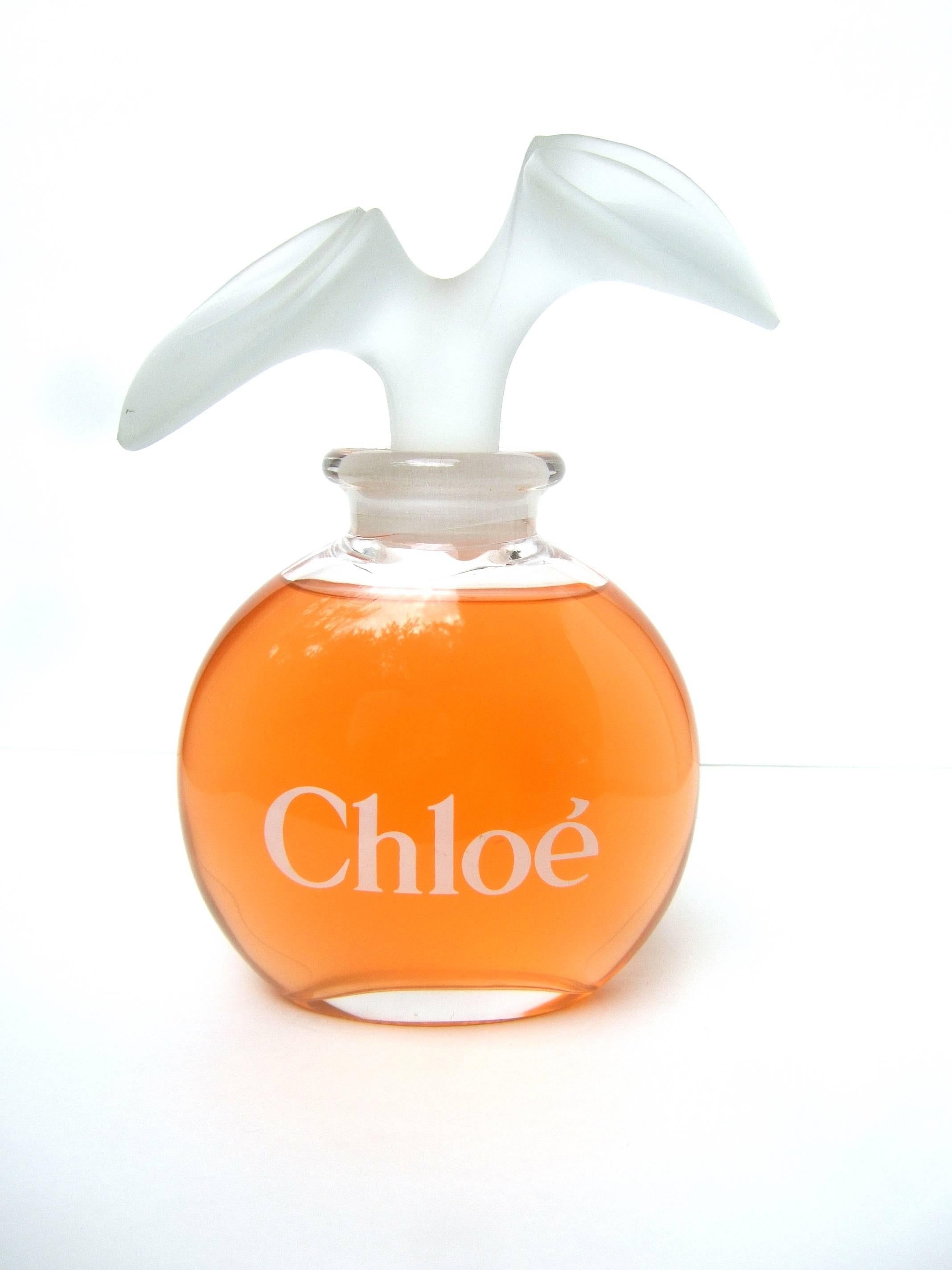 Chloe Large glass factice display bottle c 1980s
The elegant designer glass bottle was a
display bottle at the fragrance counter in a
department store 

The smooth glass oval shaped bottle is juxtaposed 
with a frosted glass large scale