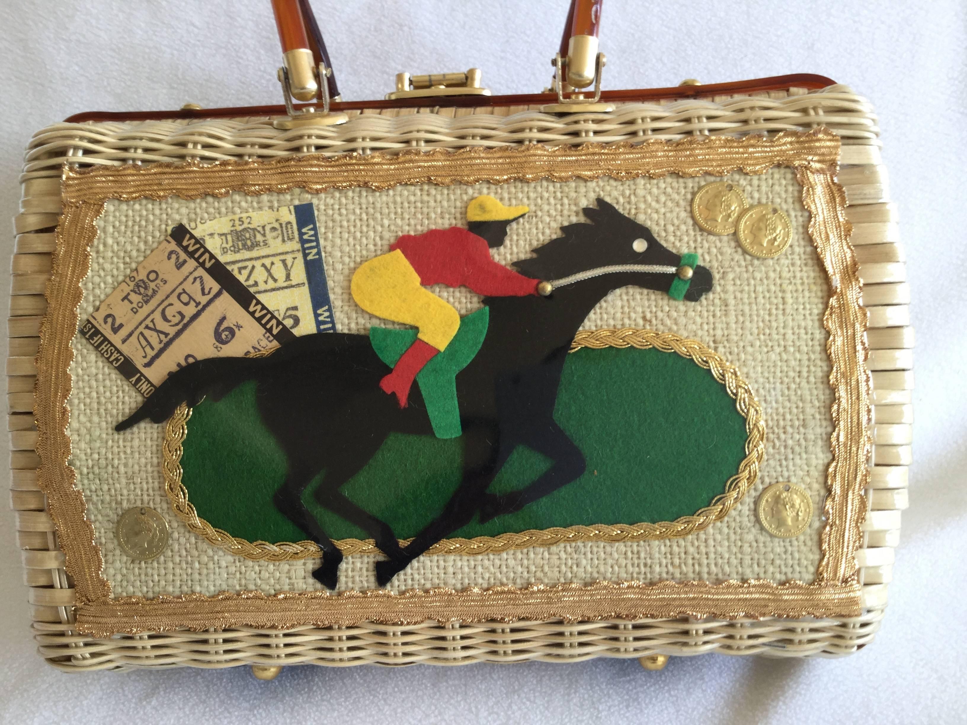 Rare vintage racing themed wicker handbag. The jockey is made from collage of brightly colored felt pieces. Golden coins and racing tickets complete the scene all of which is encased under clear vinyl. This tableau is then framed by gold metallic