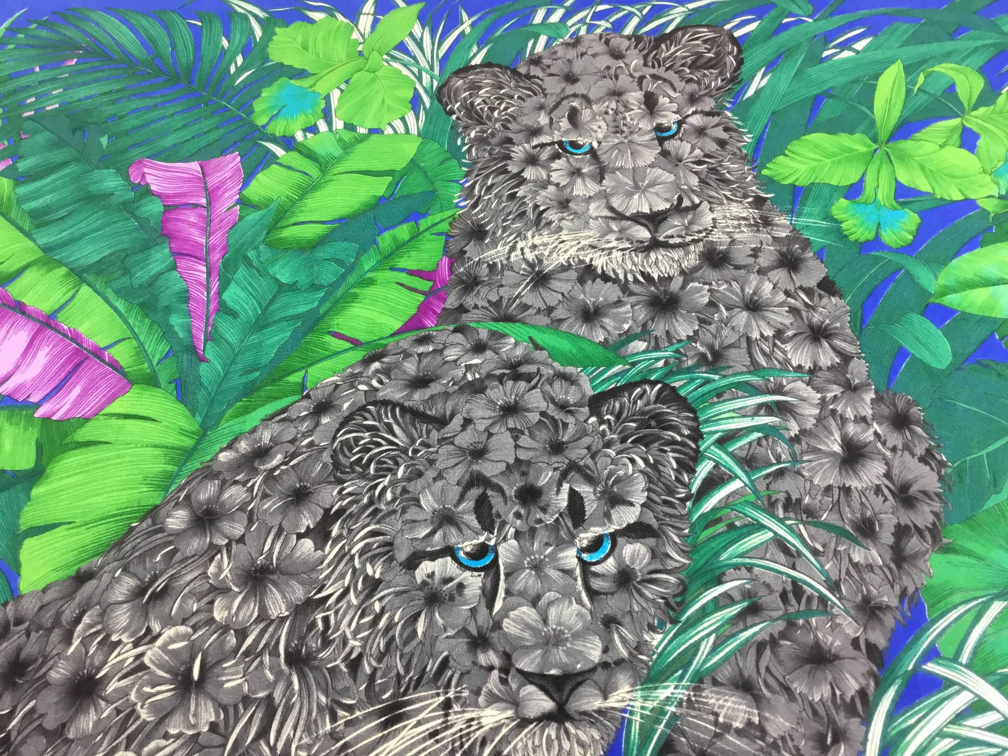 This Ferragamo scarf is so intricate and beautiful. The trio of leopard's  have
gray hibiscus flowers for fur. They are posed in a tropical jungle. The detail is simply stunning. It is 32 inches by 32 inches; so large enough to be worn as a shawl. 