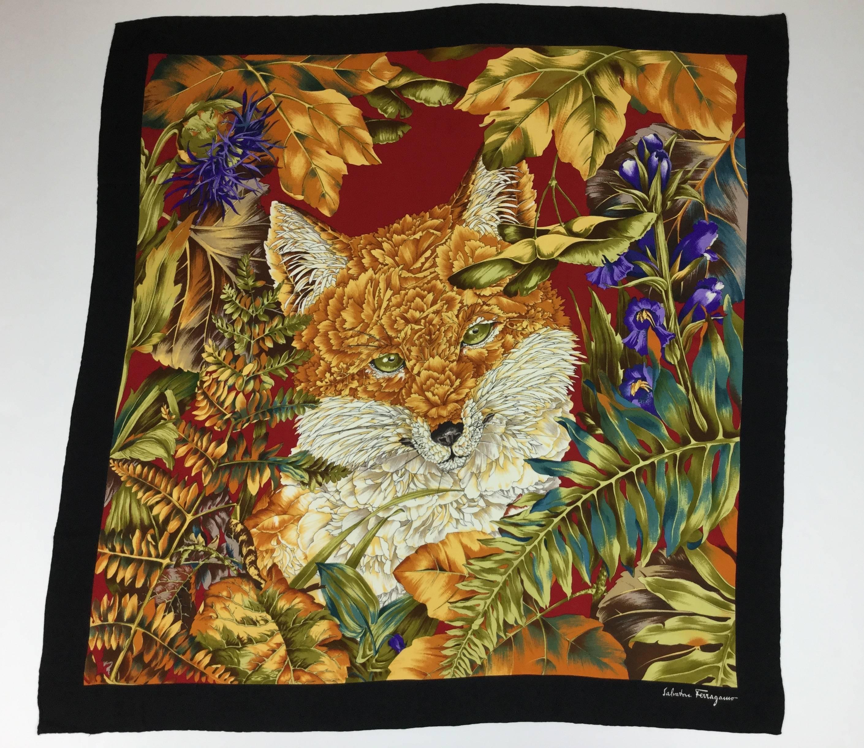 This Ferragamo scarf is so intricate and lush. The green eyed fox has auburn and creme carnation petals for fur.  She gazes from a frame of Iris blooms and
autumn toned leaves. The detail is simply stunning. It is 32 inches by 32 inches;
so large