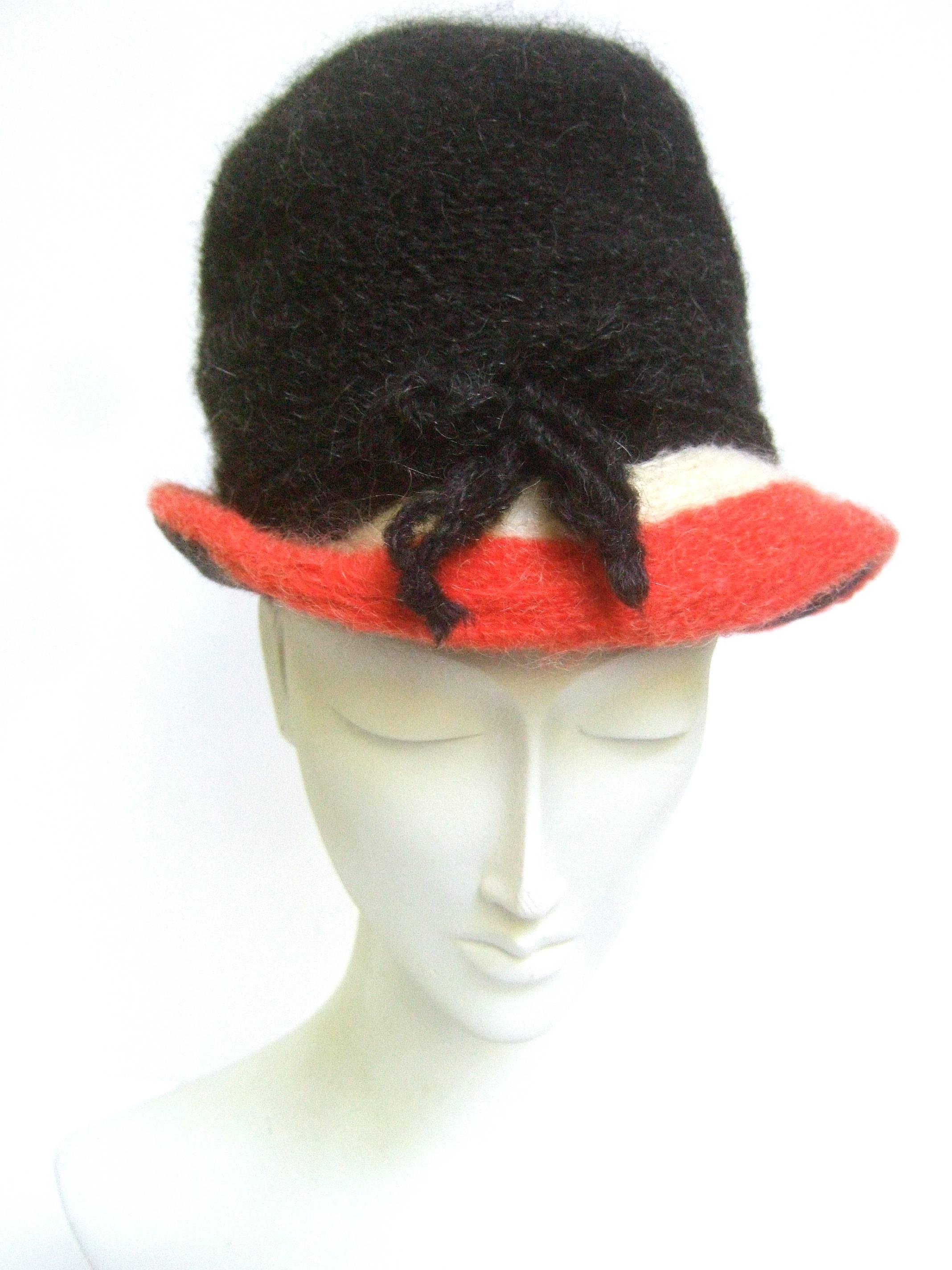 Yves Saint Laurent Stylish wool knit hat c 1970
The chic designer hat is constructed with 
color block fuzzy wool knit bands

The fuzzy gray / black wool crown is accented
with wool knit striped bands of ivory & red

Makes a very striking