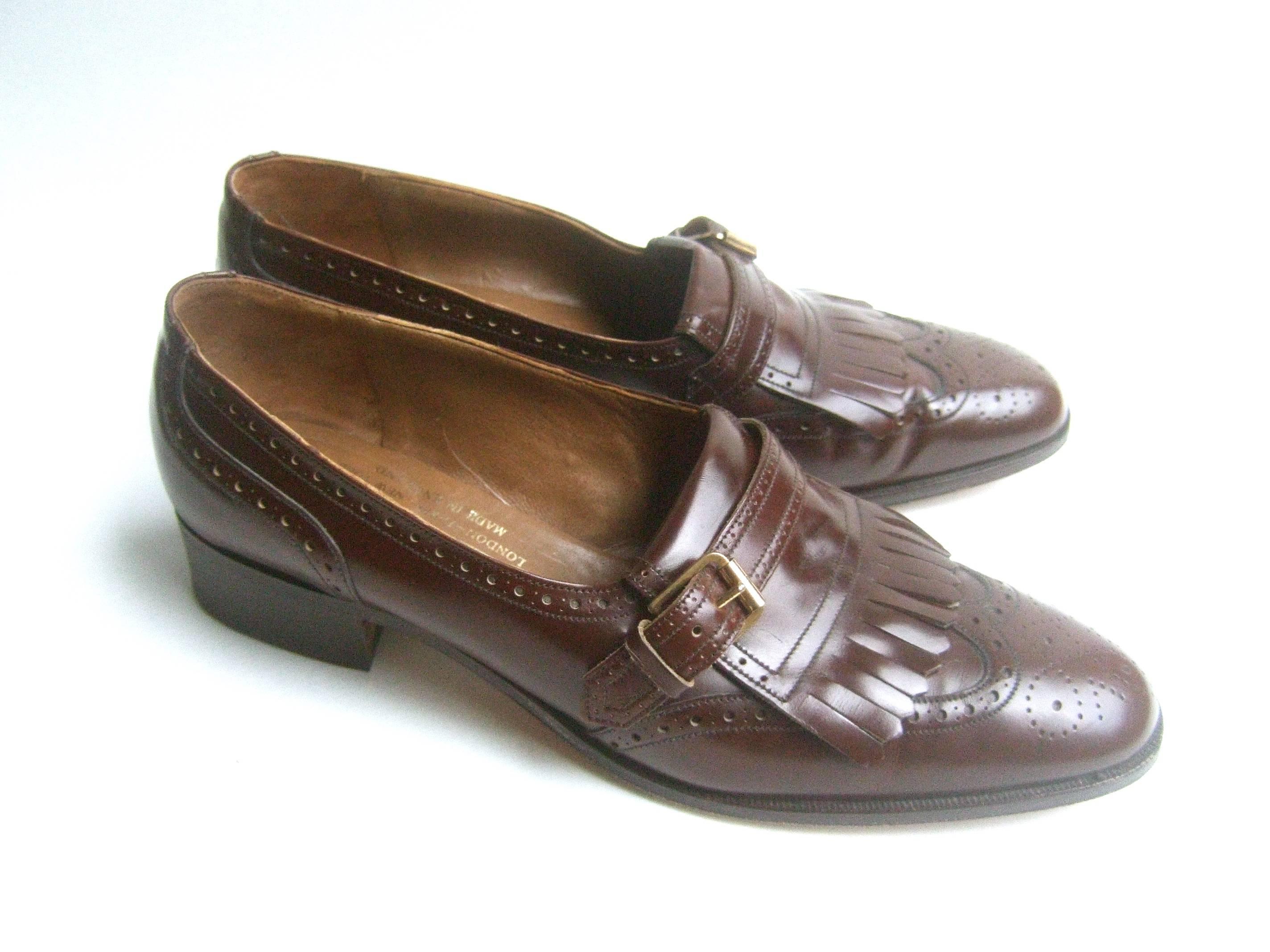 Church's London classic men's brown leather brogues
The stylish brown loafers are designed with a gilt buckle 
and perforated detail on the front and sides 

A timeless design that is eternally in style 
Labeled Church's London Paris New York 
Made