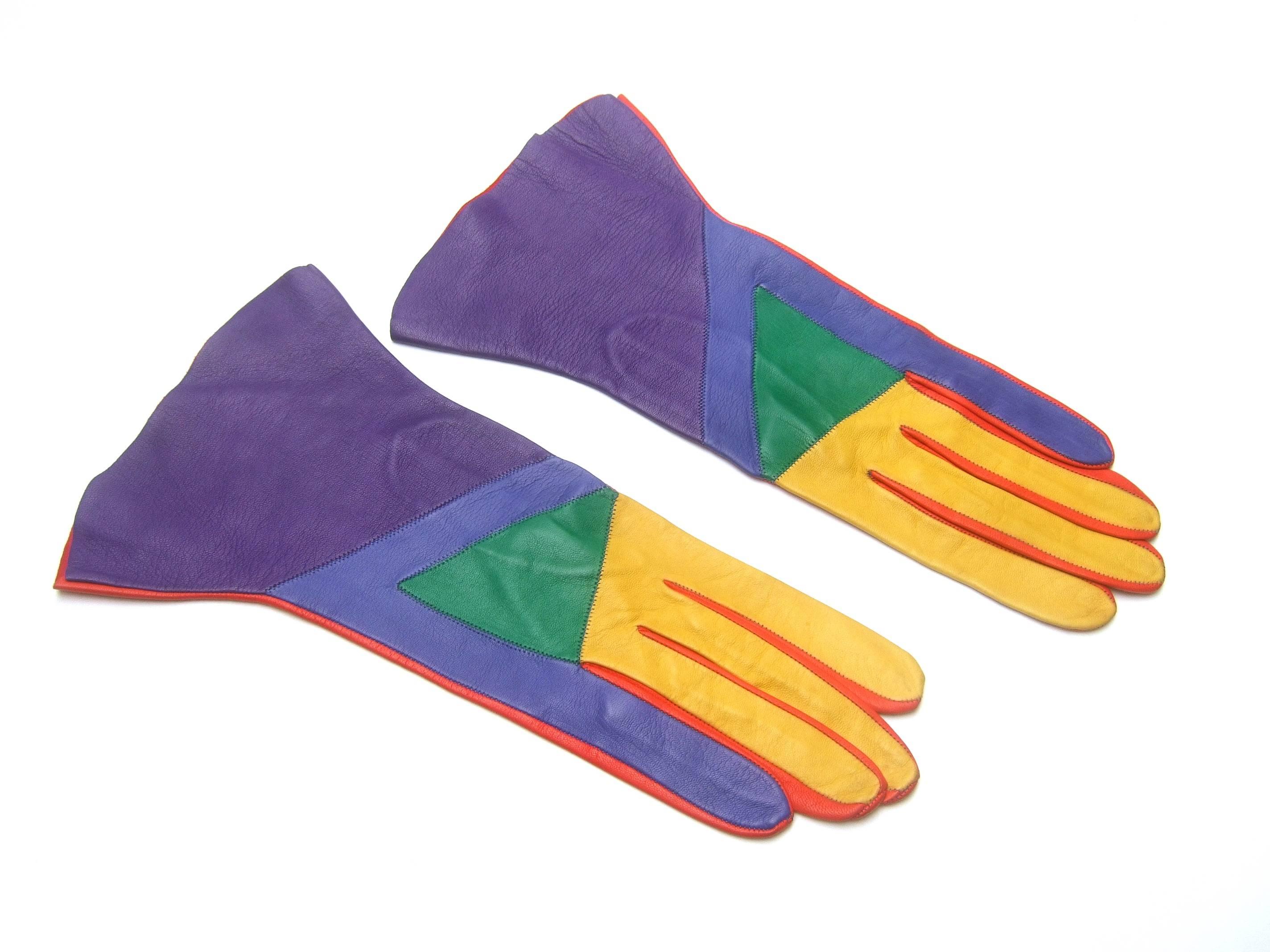 Mod Italian leather color block gloves c 1980
The chic supple leather gloves are designed 
in a spectrum of with vibrant primary colors 

In contrast the underneath leather is solid
red leather

Makes a very stylish unique accessory