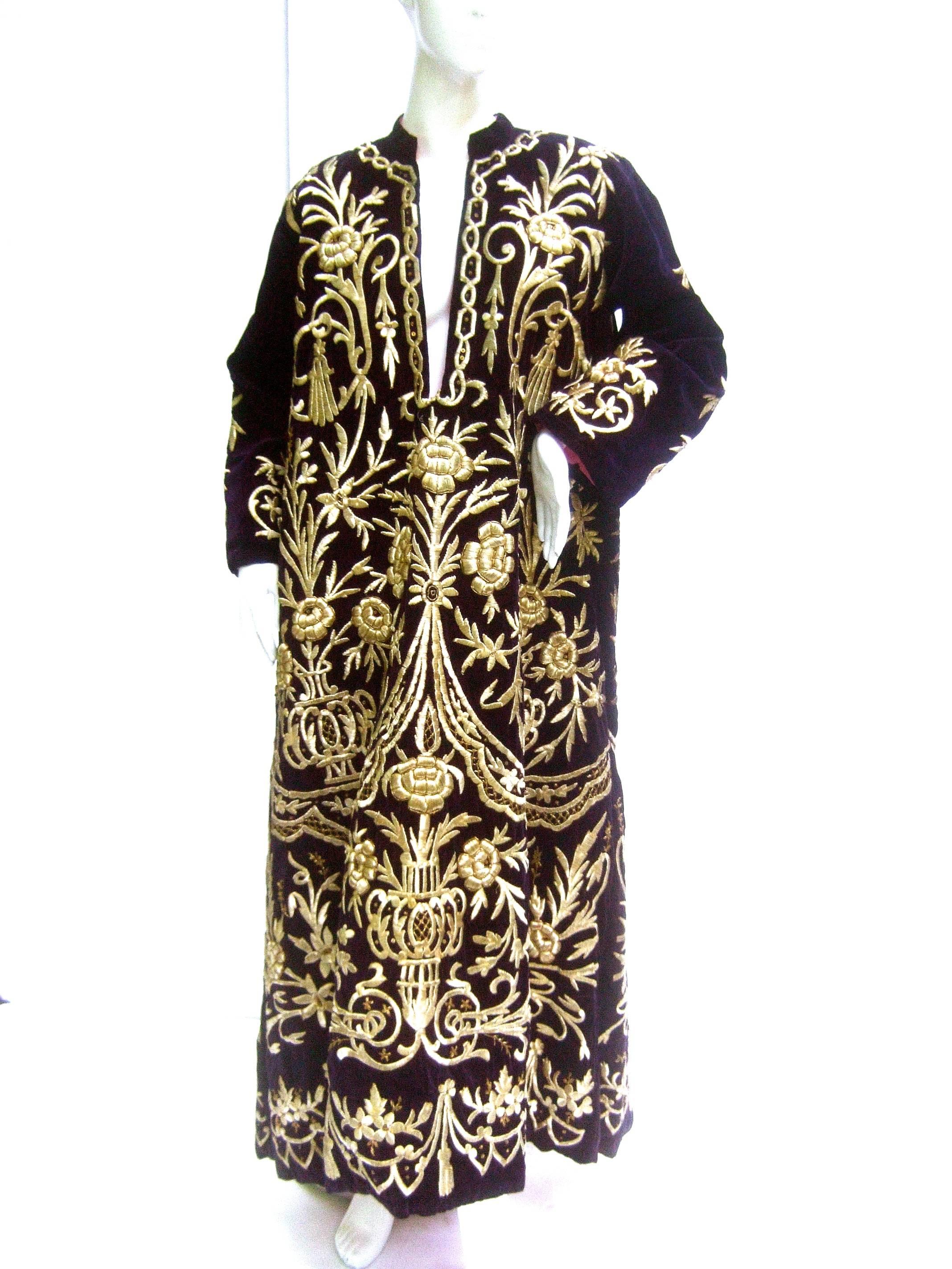 Exquisite museum worthy aubergene velvet embroidered metallic caftan 
The incredible caftan / robe is embellished with extraordinary three
dimensional gold metallic stumpwork embroidery throughout 

The mind blowing metallic hand embroidery is