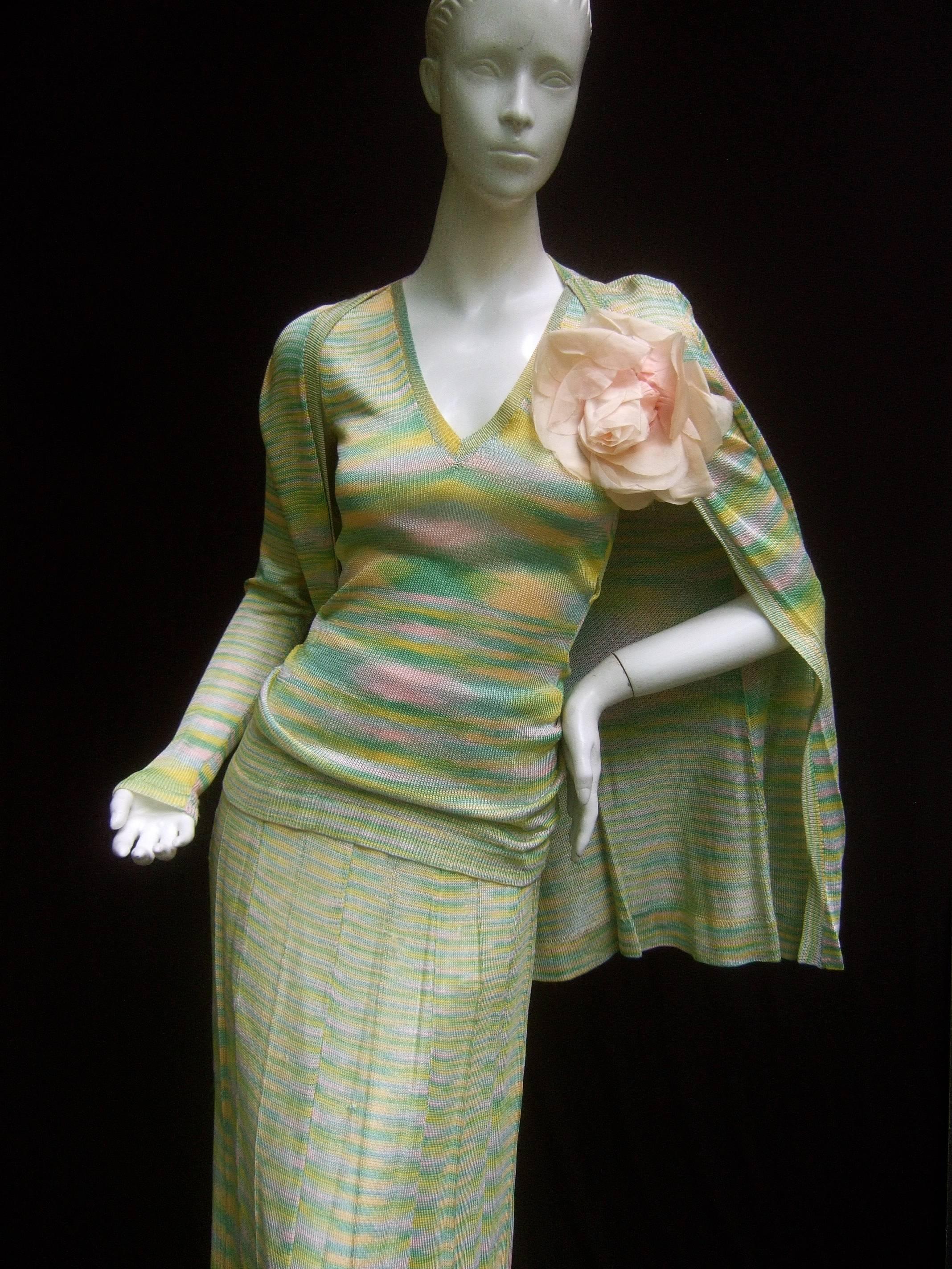 Adolfo Saks Fifth Avenue pastel knit ensemble c 1970s 
The stylish cotton knit ensemble is designed with a 
knit cardigan style sweater; paired with a knit shell
v knit tank top and long pleated maxi skirt 

The pastel knit cardigan is embellished