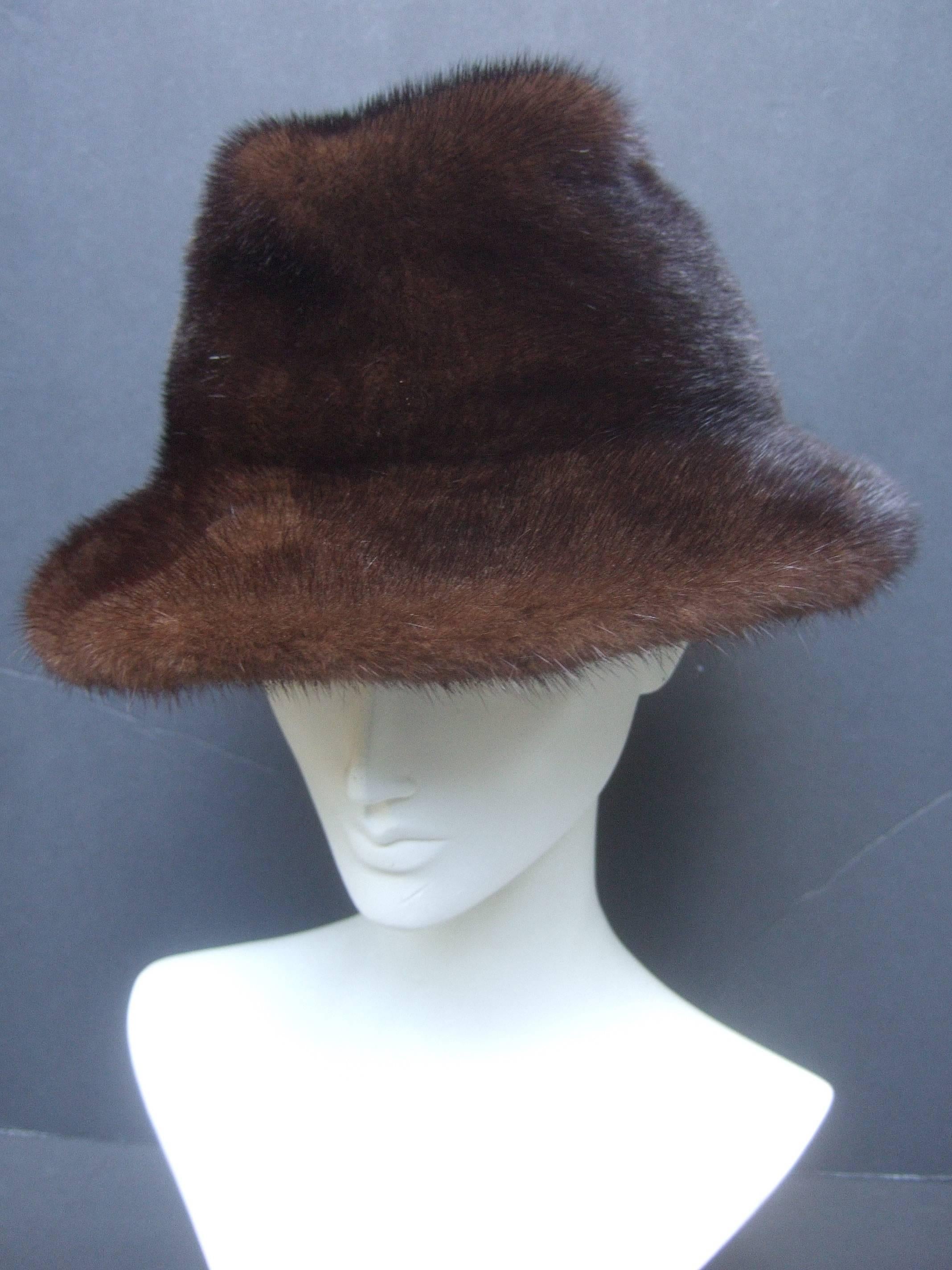Plush mink fedora hat by Adolfo II for Saks Fifth Avenue 
The stylish ranch mink hat is a lustrous mahogany 
brown  

Makes a very chic accessory 
Labeled Adolfo II Saks Fifth Avenue 
Paris  New York 

The interior head size circumference