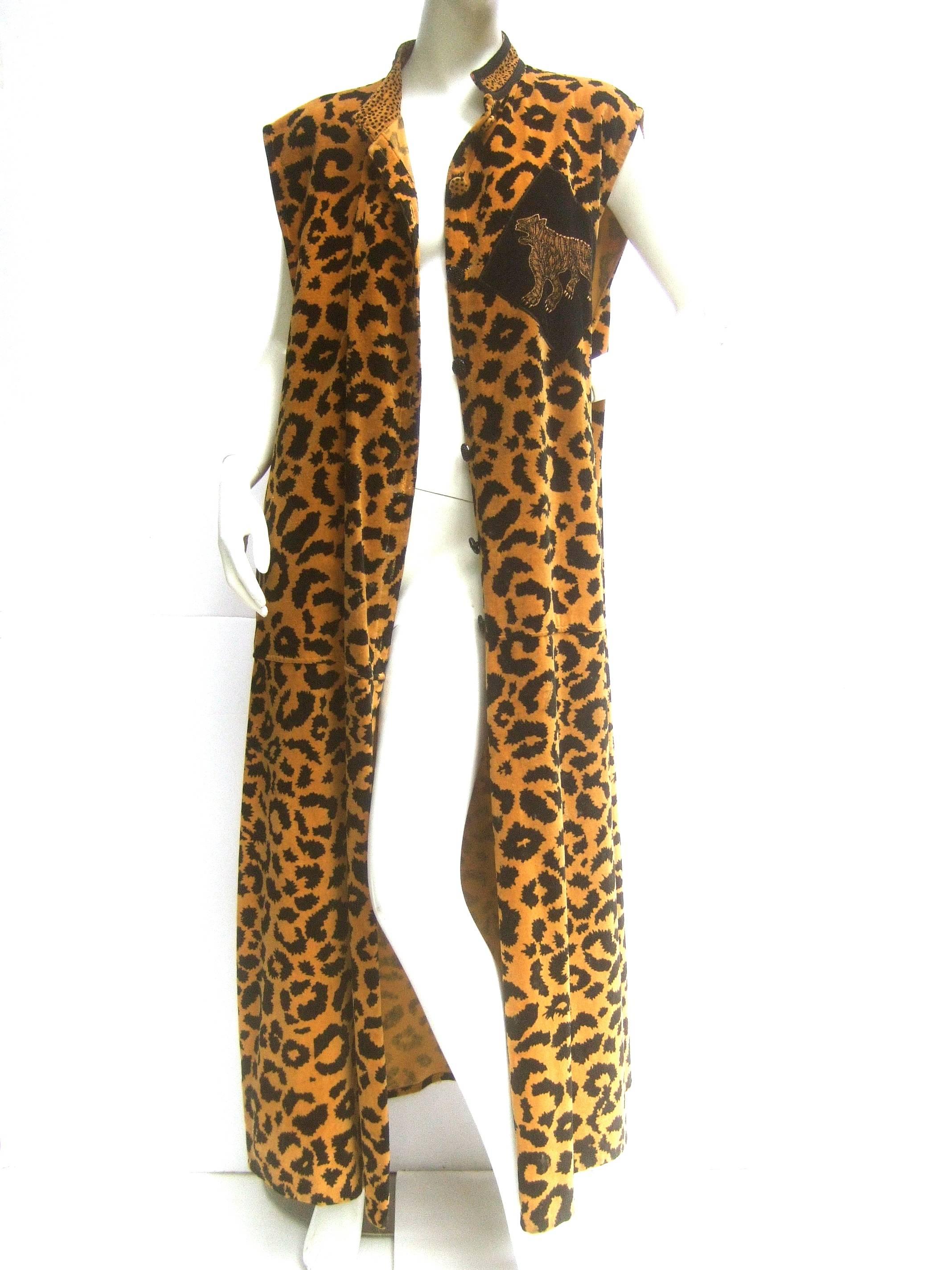 Exotic cotton velvet animal print maxi vest c 1980s
The dramatic long sweeping vest is illustrated 
with bold animal print graphics throughout 

One side of the chest is designed with an
applique jungle tiger. The back side also
has an
