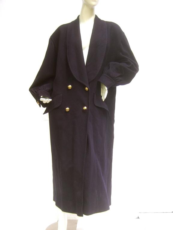 Jaeger London dark blue wool cocoon coat c 1980s
The stylish winter coat is designed plush dark 
blue wool that has a subtle military influence 

The voluminous silhouette combines comfort
and utility. Secures with a group of four gilt
metal