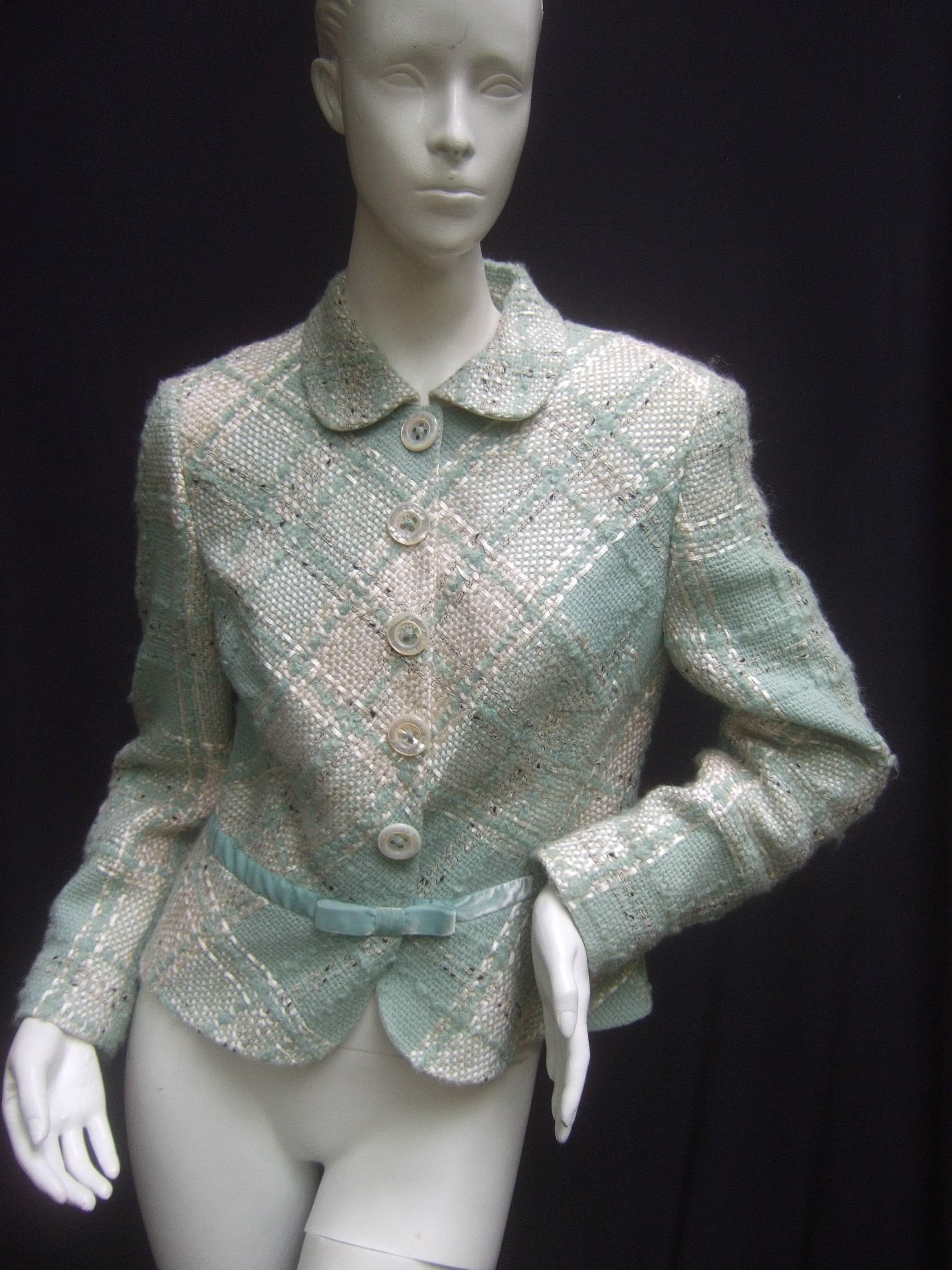 Rena Lange Pastel chunky wool knit fitted jacket 
The stylish designer jacket is a combination
of pale muted green and ivory textured knit 

Adorned with five large pearlized buttons 
that snap stamped Rena Lange. The waist 
section is