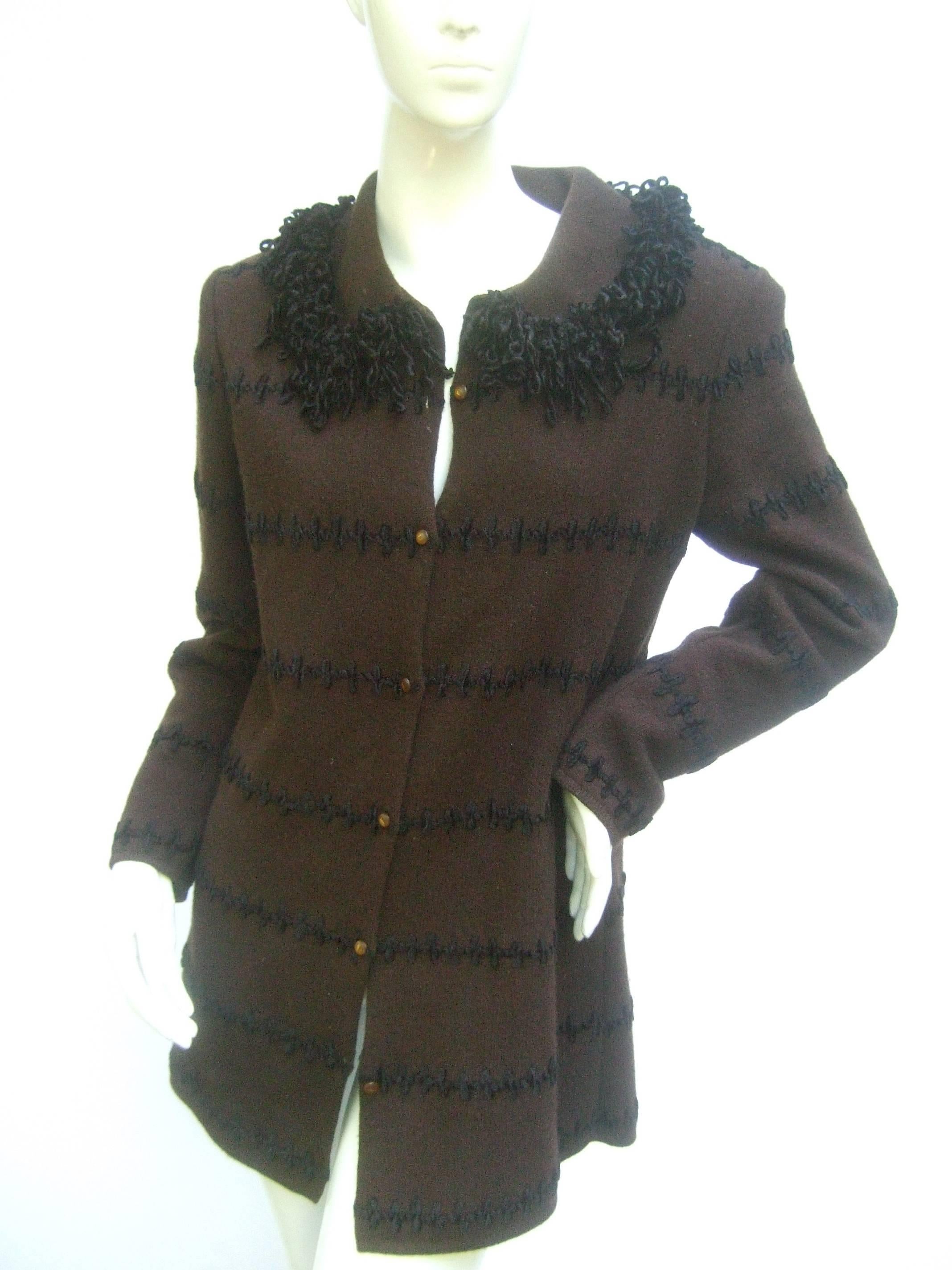 Fendi Italy Chocolate brown cardigan sweater c 1990s
The Italian brown wool knit cardigan is designed
with a black fringe knit collar and horizontal black
applique stitched knit bands 

The cardigan is adorned with small brown resin 
buttons