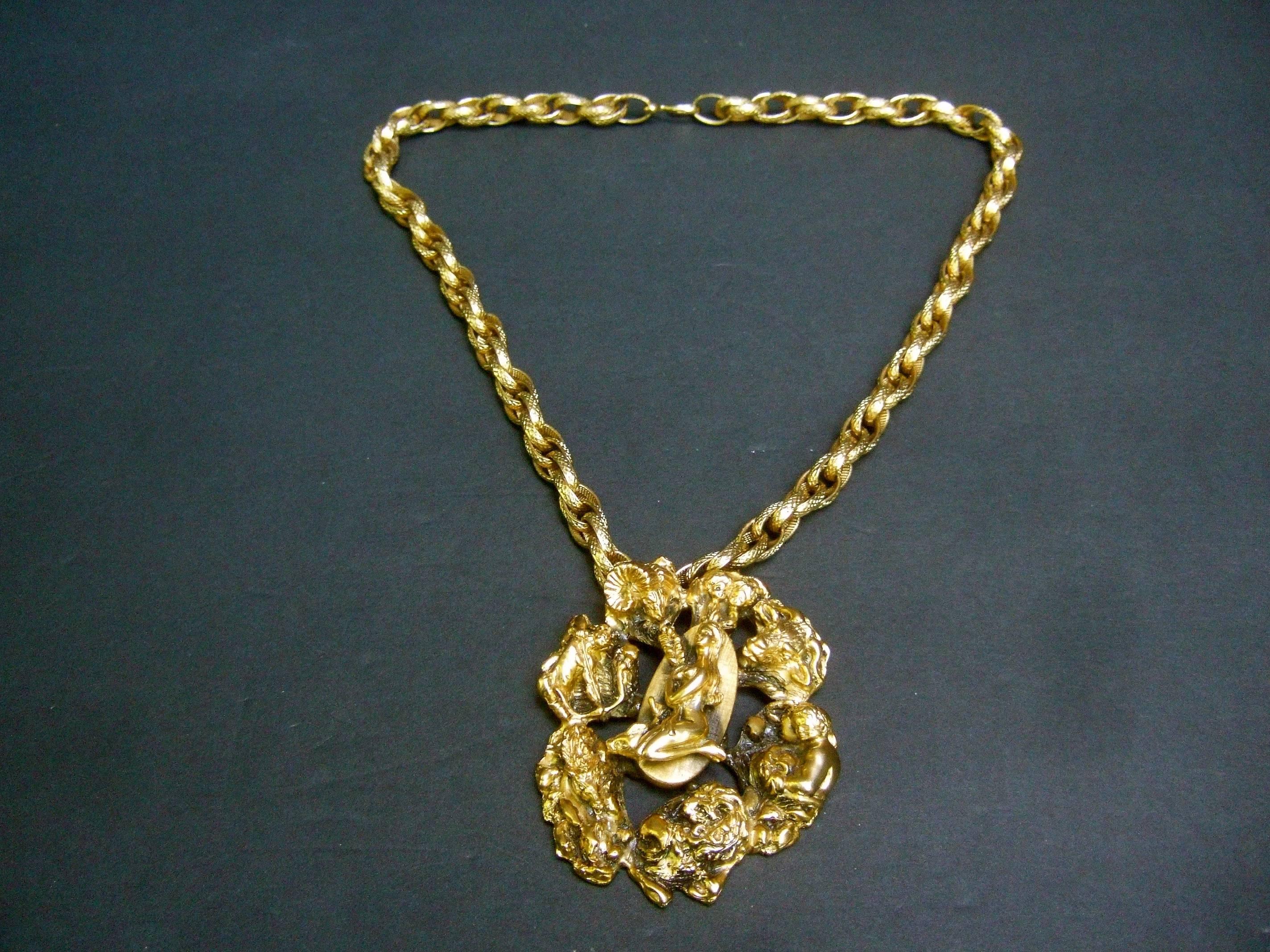 Massive gilt metal Virgo zodiac pendant necklace c 1970s 
The unique large scale pendant depicts eight 
of the astrological signs 

The center of the pendant features the female
figure for Virgo. She is surrounded by a series 
of the other